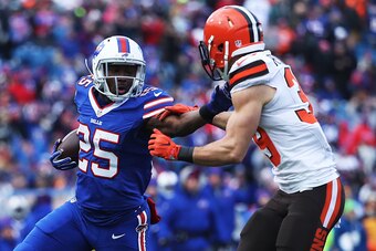 ORCHARD PARK, NY - DECEMBER 18:    LeSean McCoy #25 of the Buffalo Bills stiff arms  Ed Reynolds #39 of the Cleveland Browns during the first half at New Era Field on December 18, 2016 in Orchard Park, New York.  (Photo by Tom Szczerbowski/Getty Images)