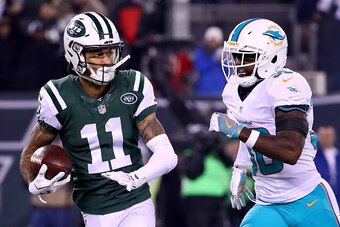 EAST RUTHERFORD, NJ - DECEMBER 17:  Robby Anderson #11 of the New York Jets runs a 40 yard touchdown pass against Bacarri Rambo #30 of the Miami Dolphins during the first quarter of the game at MetLife Stadium on December 17, 2016 in East Rutherford, New 