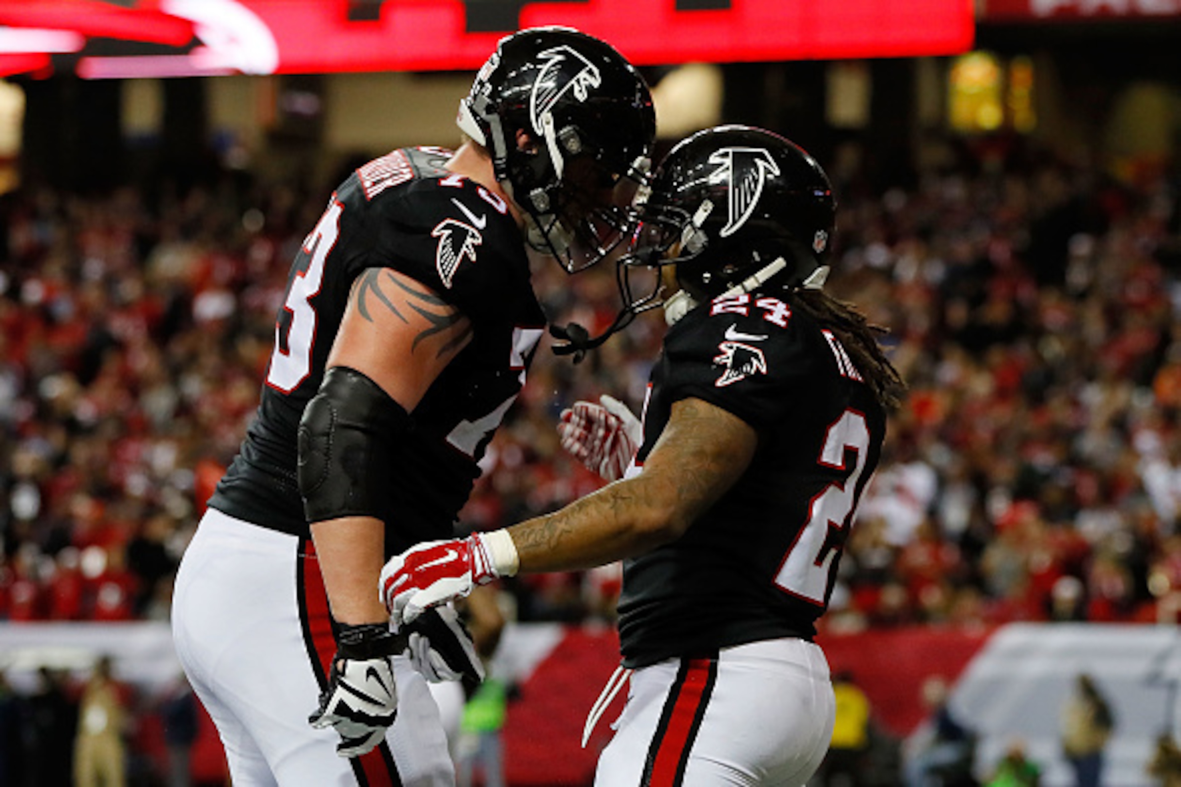 ATLANTA, GA - DECEMBER 18: Devonta Freeman #24 celebrates a touchdown with Ryan Schraeder #73 of the Atlanta Falcons during the first half against the San Francisco 49ers at the Georgia Dome on December 18, 2016 in Atlanta, Georgia. (Photo by Kevin C. Cox