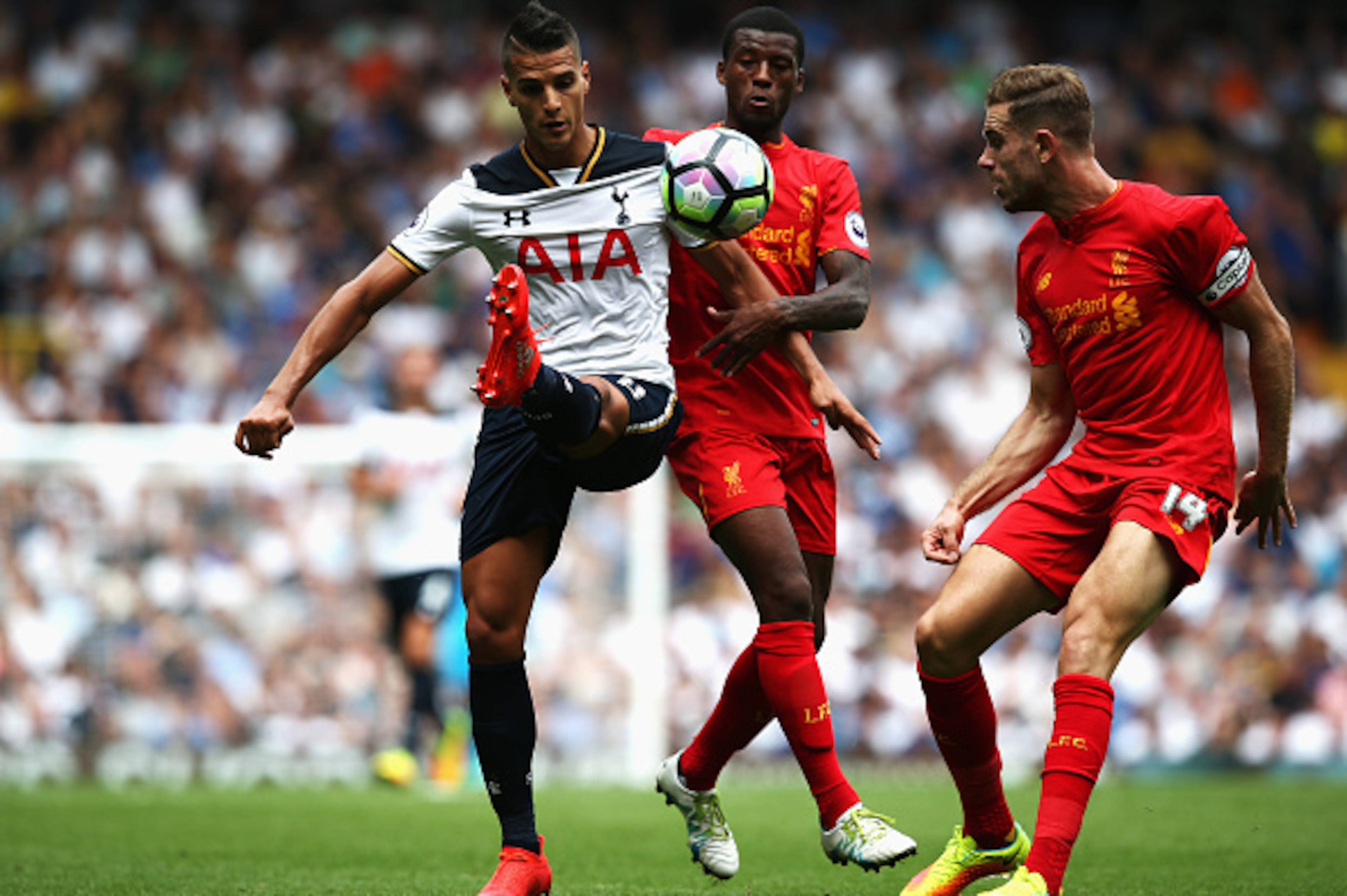 LONDON, ENGLAND - AUGUST 27: Erik Lamela of Tottenham Hotspur (L) battle for possession with Georginio Wijnaldum of Liverpool (C) while Jordan Henderson of Liverpool (R) looks on during the Premier League match between Tottenham Hotspur and Liverpool at W LONDON, ENGLAND - AUGUST 27: Erik Lamela of Tottenham Hotspur (L) battle for possession with Georginio Wijnaldum of Liverpool (C) while Jordan Henderson of Liverpool (R) looks on during the Premier League match between Tottenham Hotspur and Liverpool at W