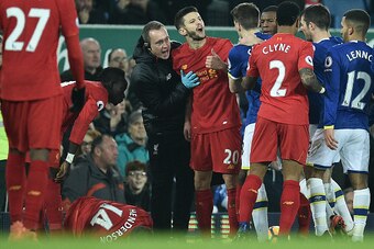 Liverpool's English midfielder Adam Lallana (C) remonstrates with Everton's Irish defender Seamus Coleman (centre R) following Everton's English midfielder Ross Barkley's (unseen) challenge on Liverpool's English midfielder Jordan Henderson during the Eng