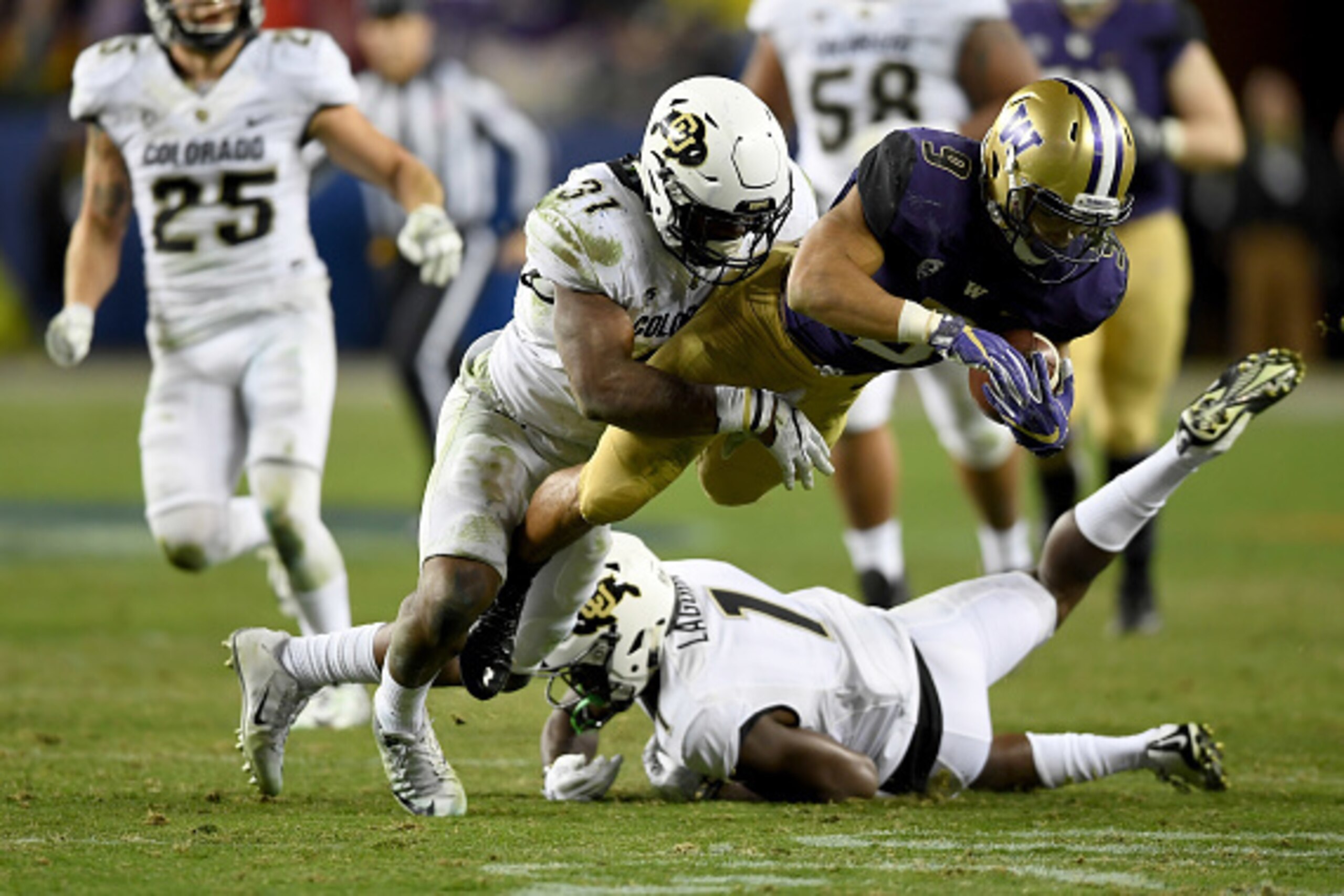 SANTA CLARA, CA - DECEMBER 02: Myles Gaskin #9 of the Washington Huskies is tackled by Kenneth Olugbode #31 of the Colorado Buffaloes during the Pac-12 Championship game at Levi's Stadium on December 2, 2016 in Santa Clara, California. (Photo by Thearon SANTA CLARA, CA - DECEMBER 02: Myles Gaskin #9 of the Washington Huskies is tackled by Kenneth Olugbode #31 of the Colorado Buffaloes during the Pac-12 Championship game at Levi's Stadium on December 2, 2016 in Santa Clara, California. (Photo by Thearon