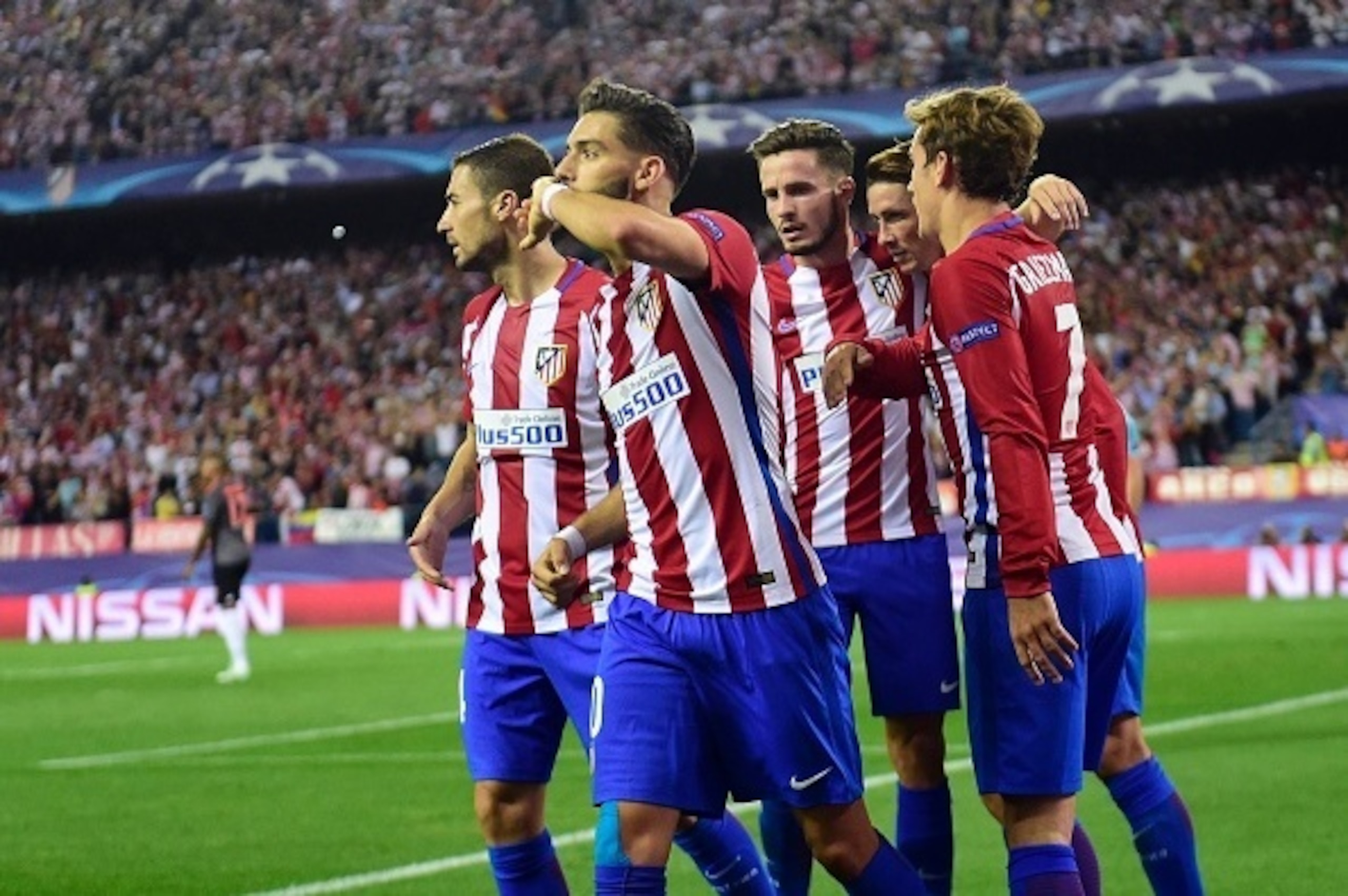 Atletico Madrid's Belgian midfielder Yannick Ferreira Carrasco (2ndL) celebrates with teammates after scoring during the UEFA Champions League Group D football match Club Atletico de Madrid vs FC Bayern Munich at the Vicente Calderon stadium in Madrid on Atletico Madrid's Belgian midfielder Yannick Ferreira Carrasco (2ndL) celebrates with teammates after scoring during the UEFA Champions League Group D football match Club Atletico de Madrid vs FC Bayern Munich at the Vicente Calderon stadium in Madrid on
