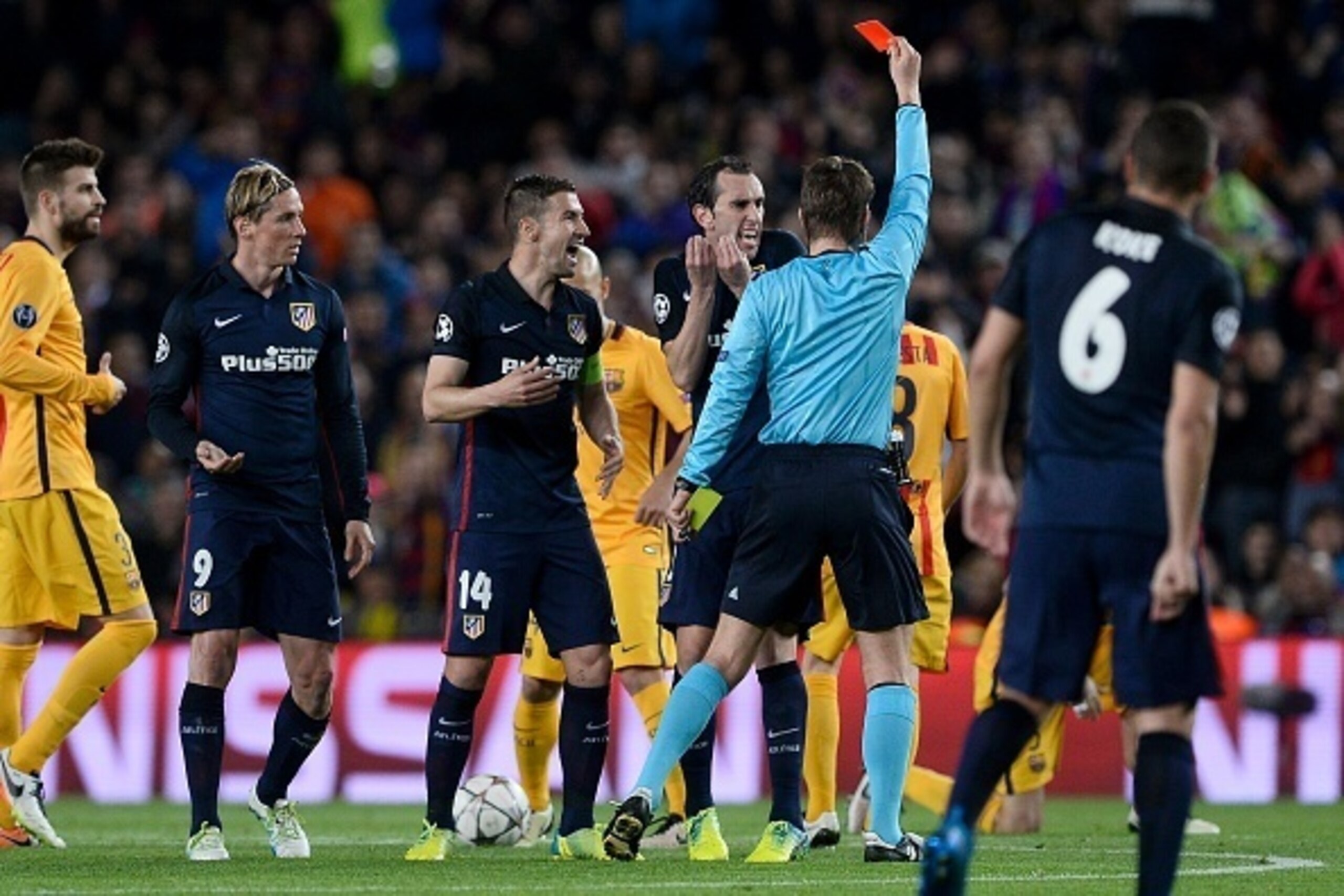 German referee Felix Brych (C) shows a red card to Atletico Madrid's forward Fernando Torres (2L) as Atletico Madrid's Uruguayan defender Diego Godin and Atletico Madrid's midfielder Gabi(3L) argue during the UEFA Champions League quarter finals first leg German referee Felix Brych (C) shows a red card to Atletico Madrid's forward Fernando Torres (2L) as Atletico Madrid's Uruguayan defender Diego Godin and Atletico Madrid's midfielder Gabi(3L) argue during the UEFA Champions League quarter finals first leg