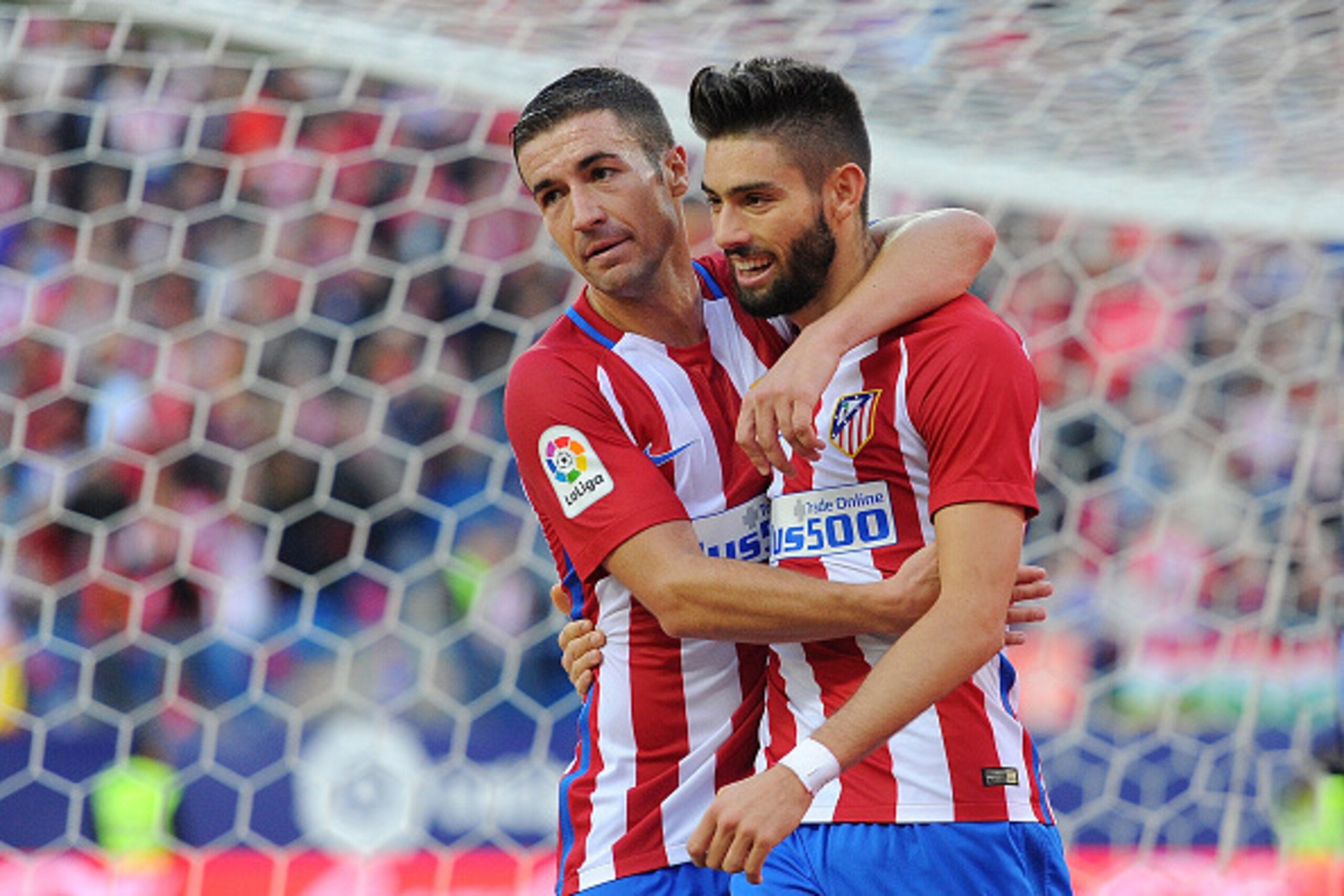 MADRID, SPAIN - OCTOBER 15:  Yannick Carrasco of Club Atletico de Madrid celebrates with Gabi Fernandez after scoring his team's opning goal during the La Liga match between Club Atletico de Madrid and Granada CF at Vicente Calderon Stadium on October 15,