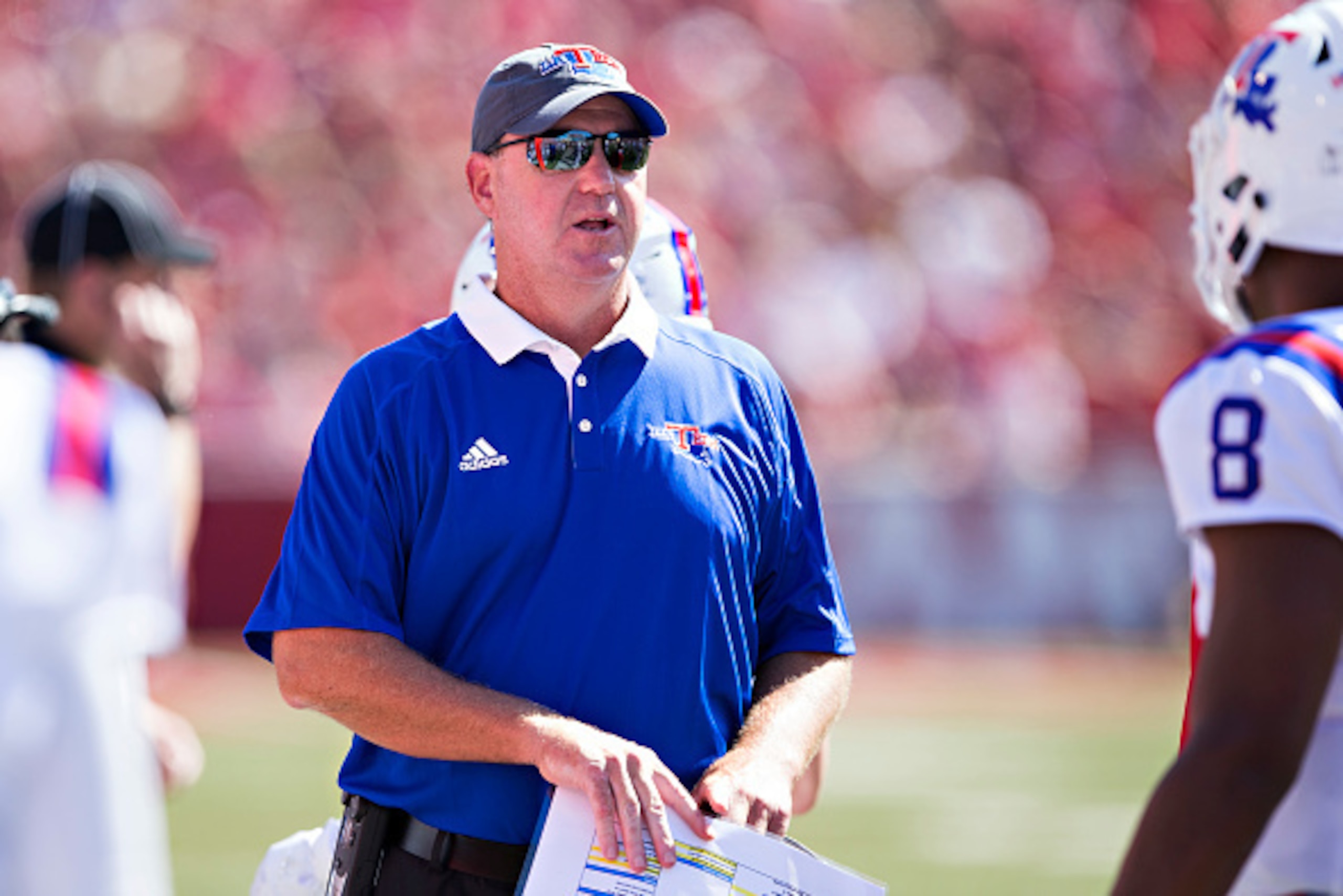 FAYETTEVILLE, AR - SEPTEMBER 3: Head Coach Skip Holtz talks with J'Mar Smith #8 of the Louisiana Tech Bulldogs on the sidelines during a game against the Arkansas Razorbacks at Razorback Stadium on September 3, 2016 in Fayetteville, Arkansas.  The Razorba