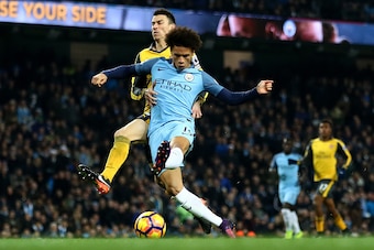 MANCHESTER, ENGLAND - DECEMBER 18: Leroy Sane of Manchester City (C) scores his sides first goal during the Premier League match between Manchester City and Arsenal at the Etihad Stadium on December 18, 2016 in Manchester, England.  (Photo by Clive Brunsk