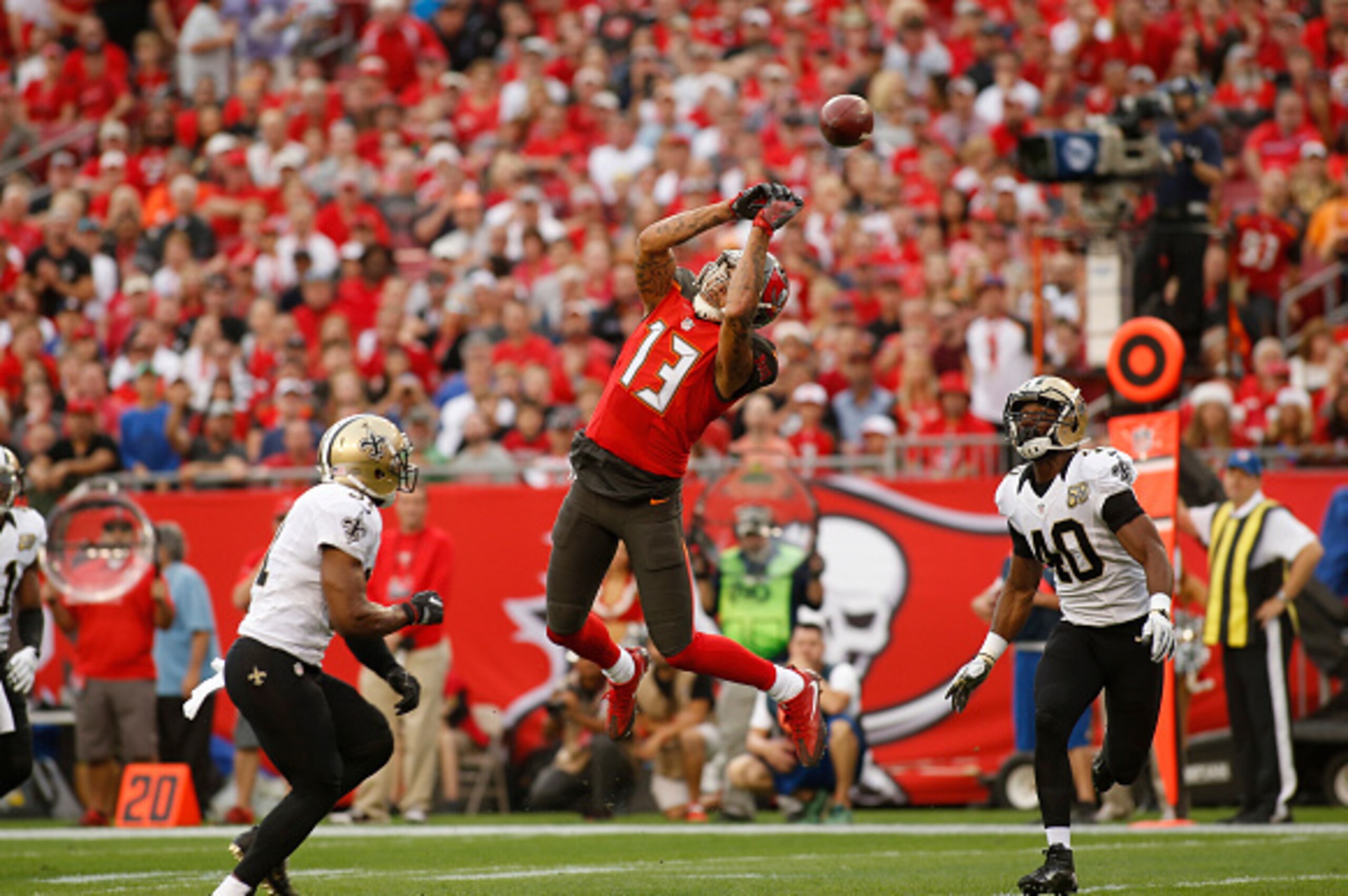 TAMPA, FL - DECEMBER 11:  wide receiver Mike Evans #13 of the Tampa Bay Buccaneers makes an attempt to haul in a pass from quarterback Jameis Winston between free safety Jairus Byrd #31 of the New Orleans Saints and cornerback Delvin Breaux #40 during the