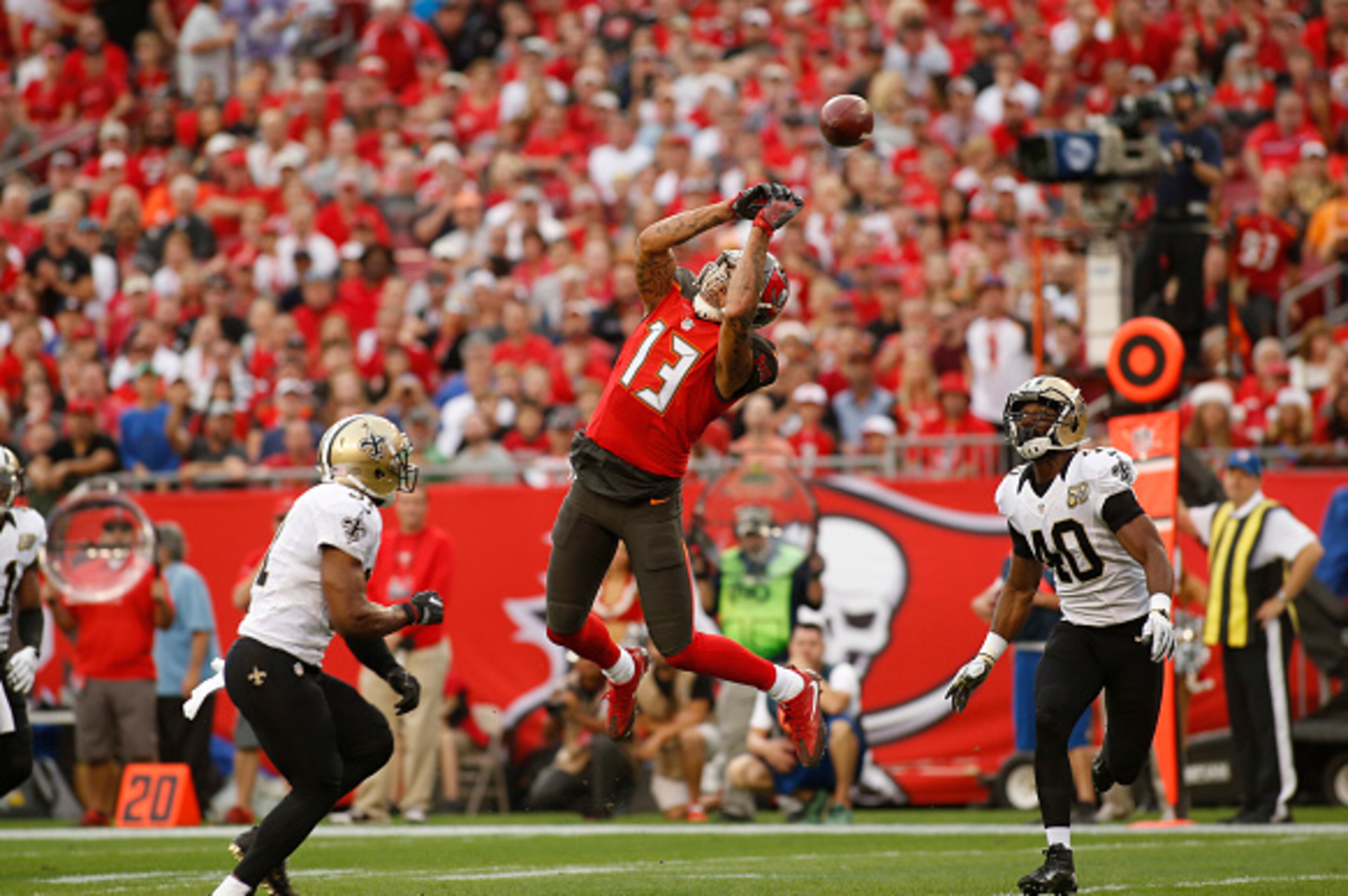 TAMPA, FL - DECEMBER 11:  wide receiver Mike Evans #13 of the Tampa Bay Buccaneers makes an attempt to haul in a pass from quarterback Jameis Winston between free safety Jairus Byrd #31 of the New Orleans Saints and cornerback Delvin Breaux #40 during the