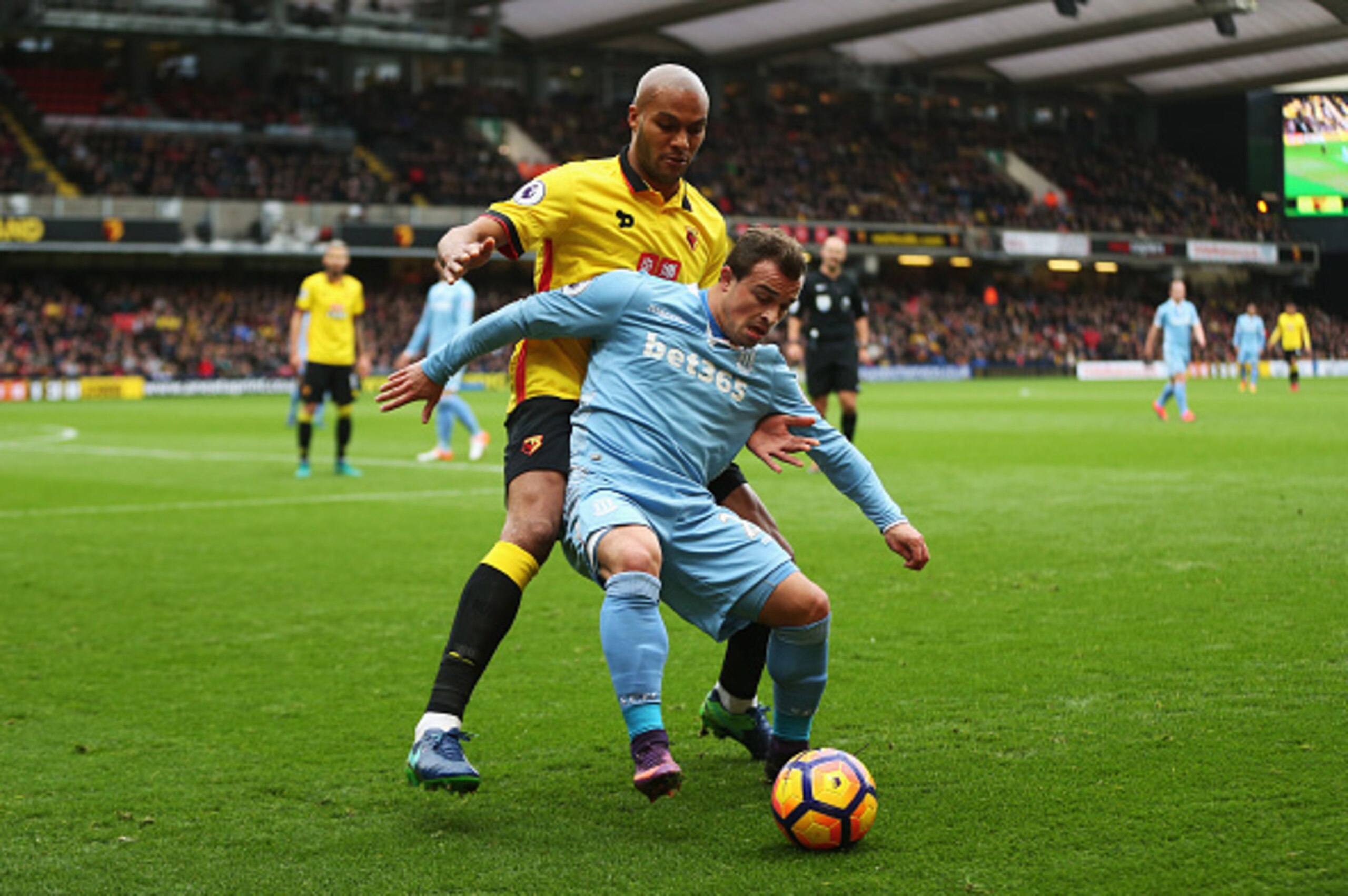 WATFORD, ENGLAND - NOVEMBER 27: Younes Kaboul of Watford (L) and Xherdan Shaqiri of Stoke City (R) battle for possession during the Premier League match between Watford and Stoke City at Vicarage Road on November 27, 2016 in Watford, England.  (Photo by A
