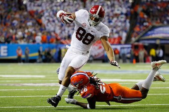 ATLANTA, GA - DECEMBER 03:  Marcell Harris #26 of the Florida Gators tackles O.J. Howard #88 of the Alabama Crimson Tide in the first half during the SEC Championship game at the Georgia Dome on December 3, 2016 in Atlanta, Georgia.  (Photo by Kevin C. Co