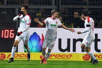 (L to R) Augsburg's South Korean forward Dong-Won Ji, Augsburg's Austrian midfielder Georg Teigl and Augsburg's Czech midfielder Jan Moravek celebrate after Moravek scored during the German First division Bundesliga football match between Borussia Dortmun