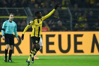 Dortmund's French midfielder Ousmane Dembele celebrates scoring during the German First division Bundesliga football match between Borussia Dortmund and FC Augsburg, in Dortmund, western Germany, on December 20, 2016.  / AFP / PATRIK STOLLARZ / RESTRICTIO