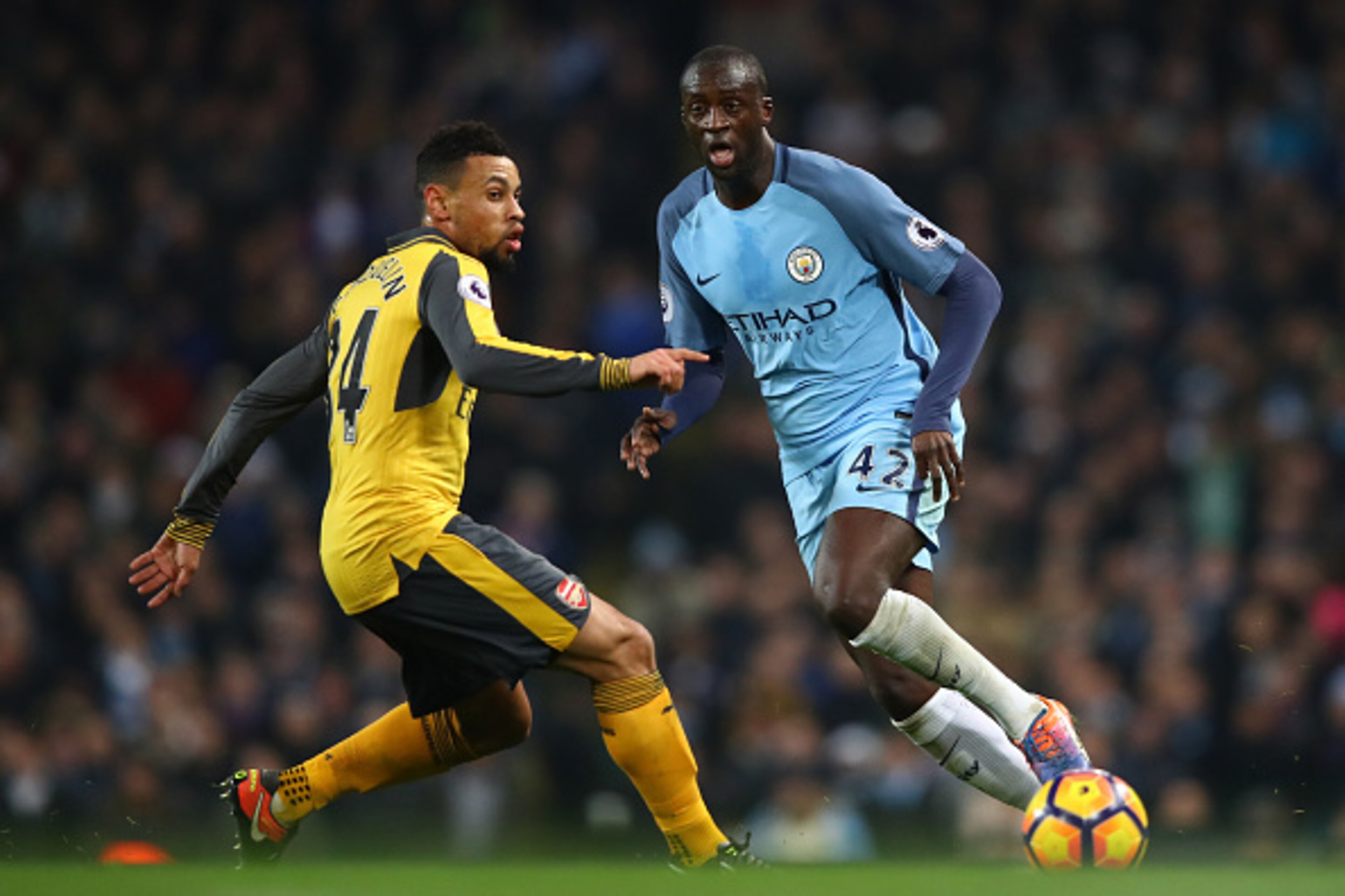 MANCHESTER, ENGLAND - DECEMBER 18: Francis Coquelin of Arsneal (L) and Yaya Toure of Manchester City (R) both watch the ball during the Premier League match between Manchester City and Arsenal at the Etihad Stadium on December 18, 2016 in Manchester, Engl MANCHESTER, ENGLAND - DECEMBER 18: Francis Coquelin of Arsneal (L) and Yaya Toure of Manchester City (R) both watch the ball during the Premier League match between Manchester City and Arsenal at the Etihad Stadium on December 18, 2016 in Manchester, Engl