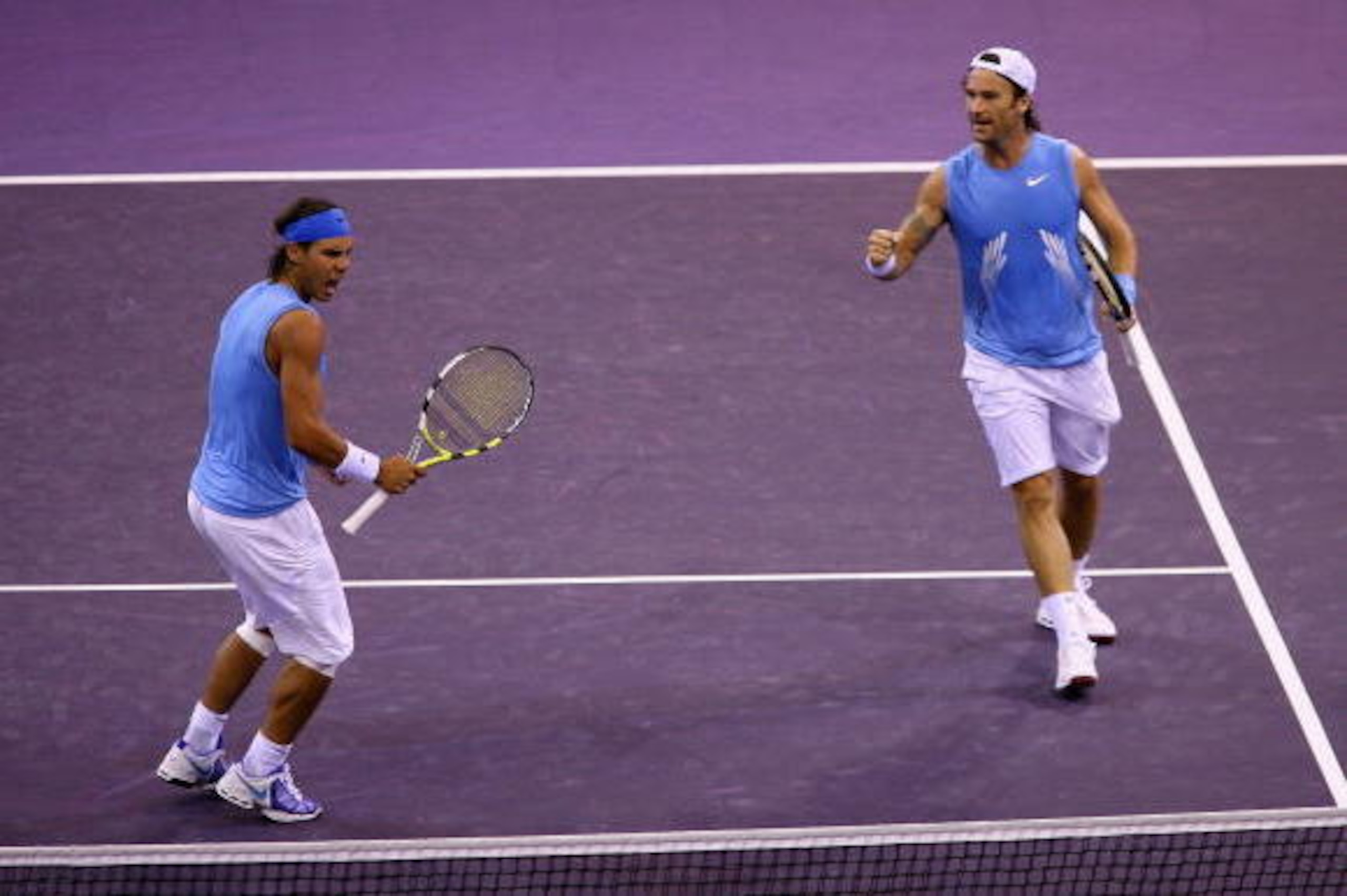MADRID, SPAIN - OCTOBER 13:  Rafael Nadal (L)and Carlos Moya of Spain celebrate a point against Mardy Fish and James Blake of the USA during their first round doubles match at the Madrid Masters tennis tournament at the Madrid Arena on October 13, 2008 in