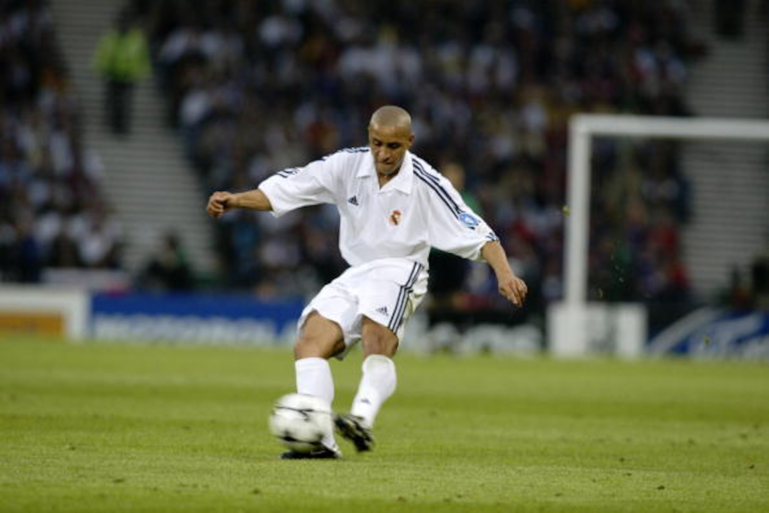 GLASGOW - May 15:  Roberto Carlos of Real Madrid passes the ball during the UEFA Champions League Final between Real Madrid and Bayer Leverkusen played at Hampden Park, in Glasgow, Scotland on May 15, 2002. Real Madrid won the match and cup 2-1. DIGITAL I