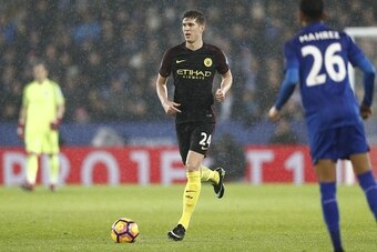 Manchester City's English defender John Stones runs with the ball during the English Premier League football match between Leicester City and Manchester City at King Power Stadium in Leicester, central England on December 10, 2016. / AFP / Adrian DENNIS /