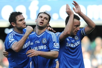Chelsea's English defender John Terry (R) celebrates with English midfielder Frank Lampard (L) and Serbian defender Branislav Ivanovic (C) at the end of the English Premier League football match between Chelsea and Everton at Stamford Bridge in London on 