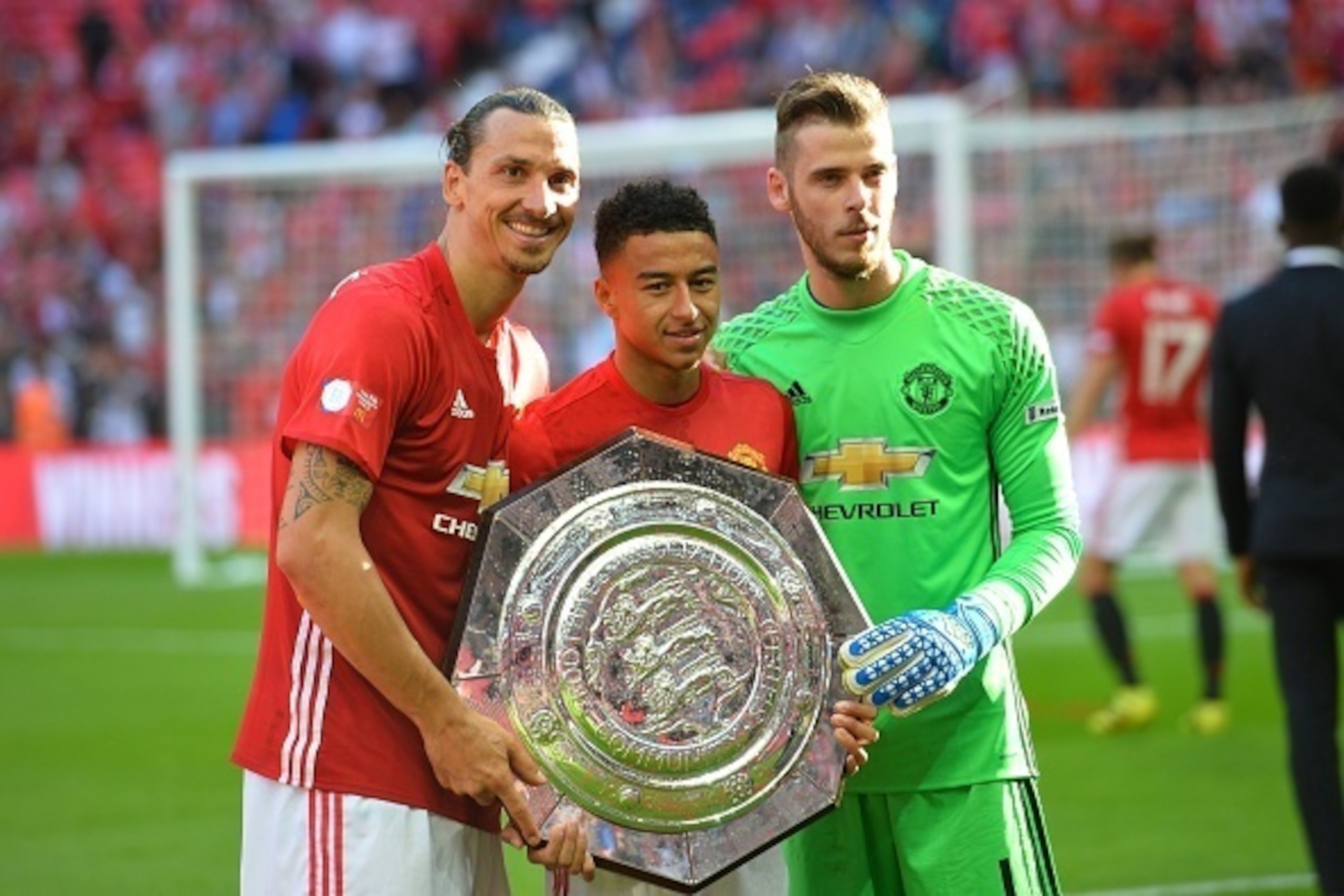 (L-R) Manchester United's Swedish striker Zlatan Ibrahimovic, Manchester United's English midfielder Jesse Lingard and Manchester United's Spanish goalkeeper David de Gea pose with the Community Shield during the trophy presentation after Manchester Unite