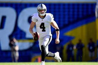 SAN DIEGO, CA - DECEMBER 18:  Derek Carr #4 of the Oakland Raiders scrambles out of the pocket for a first down during the first quarter against the San Diego Chargers at Qualcomm Stadium on December 18, 2016 in San Diego, California.  (Photo by Harry How