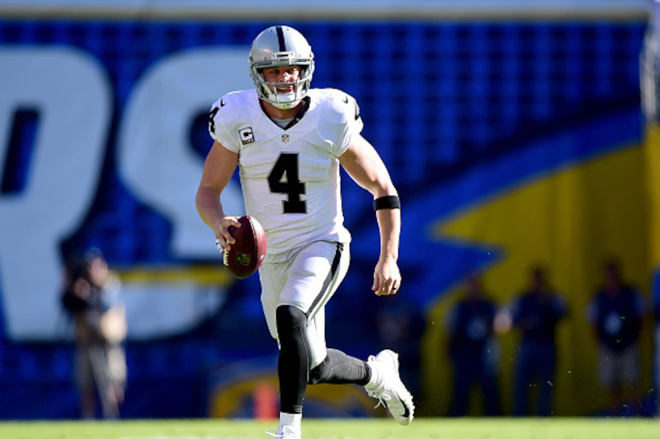 SAN DIEGO, CA - DECEMBER 18:  Derek Carr #4 of the Oakland Raiders scrambles out of the pocket for a first down during the first quarter against the San Diego Chargers at Qualcomm Stadium on December 18, 2016 in San Diego, California.  (Photo by Harry How