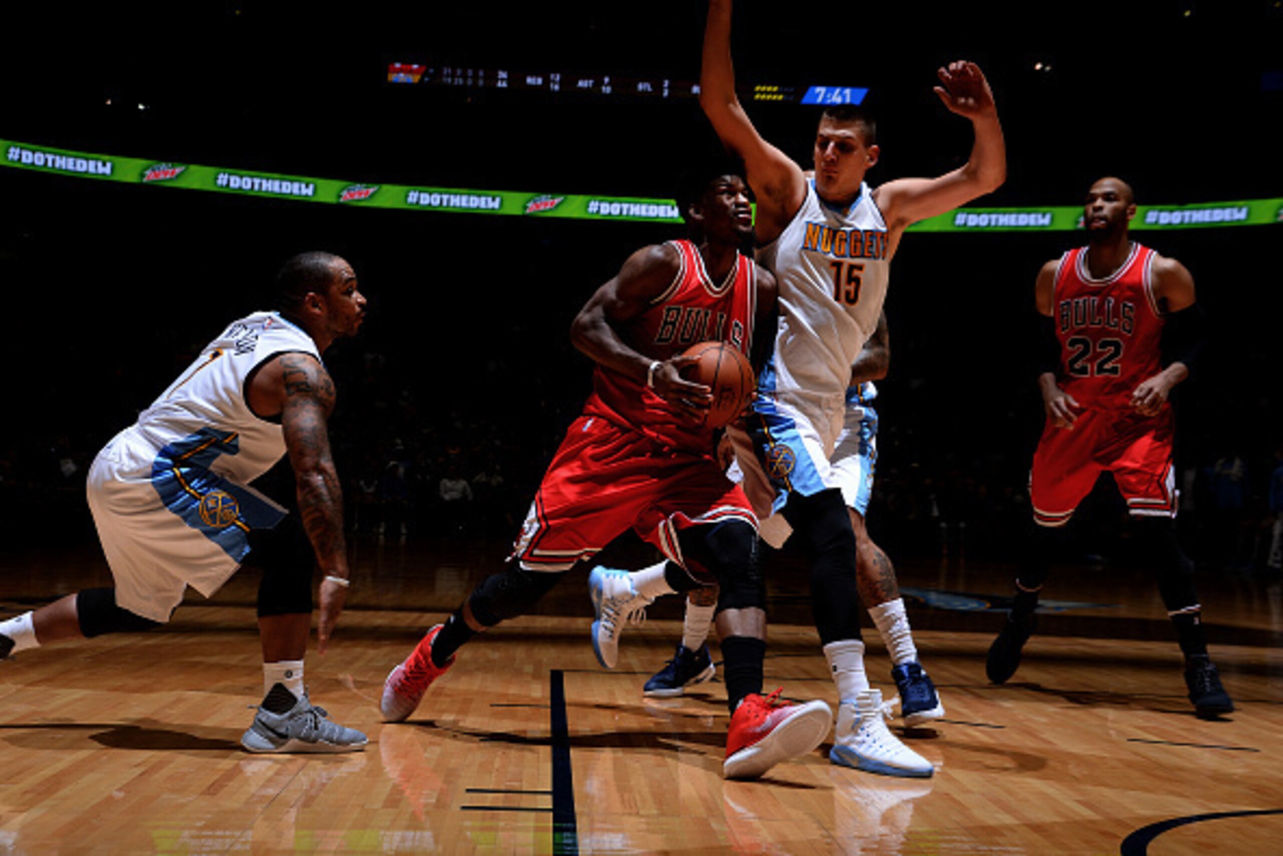 DENVER, CO - NOVEMBER 22:  Jimmy Butler #21 of the Chicago Bulls goes for a lay up against Nikola Jokic #15 of the Denver Nuggets during the game on November 22, 2016 at the Pepsi Center in Denver, Colorado. NOTE TO USER: User expressly acknowledges and a
