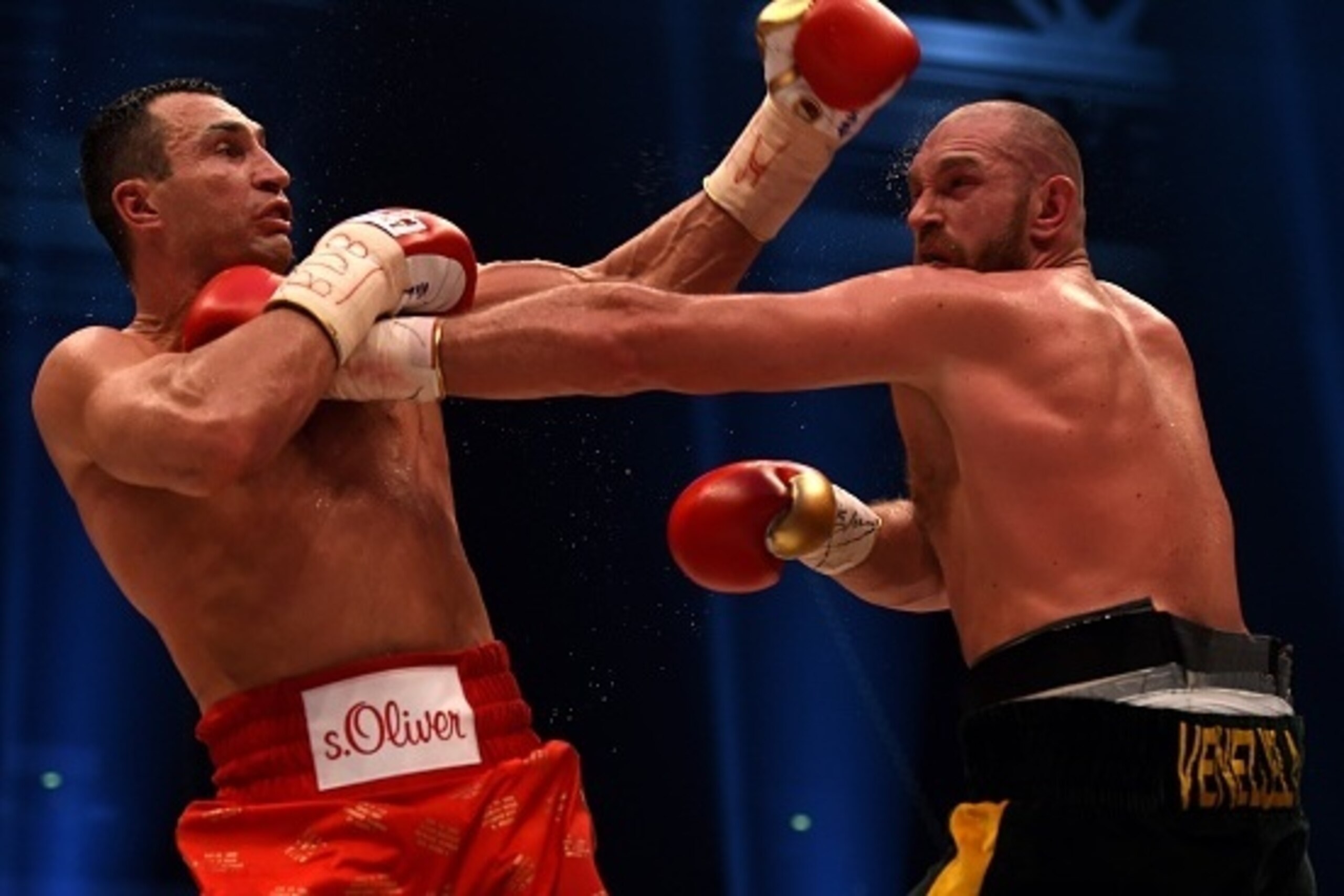 World heavyweight boxing champion Wladimir Klitschko (L) of Ukraine defends against Britain's Tyson Fury during their  WBA, IBF, WBO and IBO title bout in Duesseldorf, western Germany, on November 28, 2015.   Fury dethroned  Klitschko in a 12round decisio