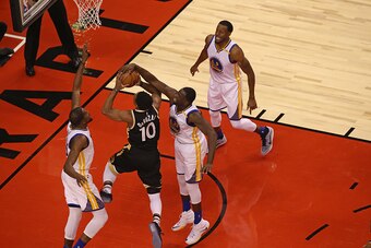 TORONTO,ON - NOVEMBER 16 2016:  Draymond Green #23 of the Golden State Warriors blocks a shot against DeMar DeRozan #10 of the Toronto Raptors during their game at Air Canada Centre on November 16, 2016 in Toronto, Ontario, Canada. NOTE TO USER: User expr