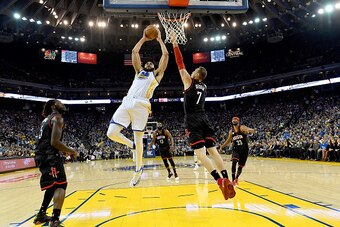 OAKLAND, CA - DECEMBER 01:  JaVale McGee #1 of the Golden State Warriors goes up to attempt to slam dunk over Sam Dekker #7 of the Houston Rockets during their NBA basketball game at ORACLE Arena on December 1, 2016 in Oakland, California. NOTE TO USER: U