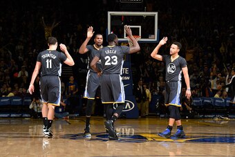 OAKLAND, CA - DECEMBER 17: Draymond Green #23, Stephen Curry #30, Kevin Durant #35 and Klay Thompson #11 of the Golden State Warriors high five each other during the game against the Portland Trail Blazers on December 17, 2016 in Oakland, California. NOTE