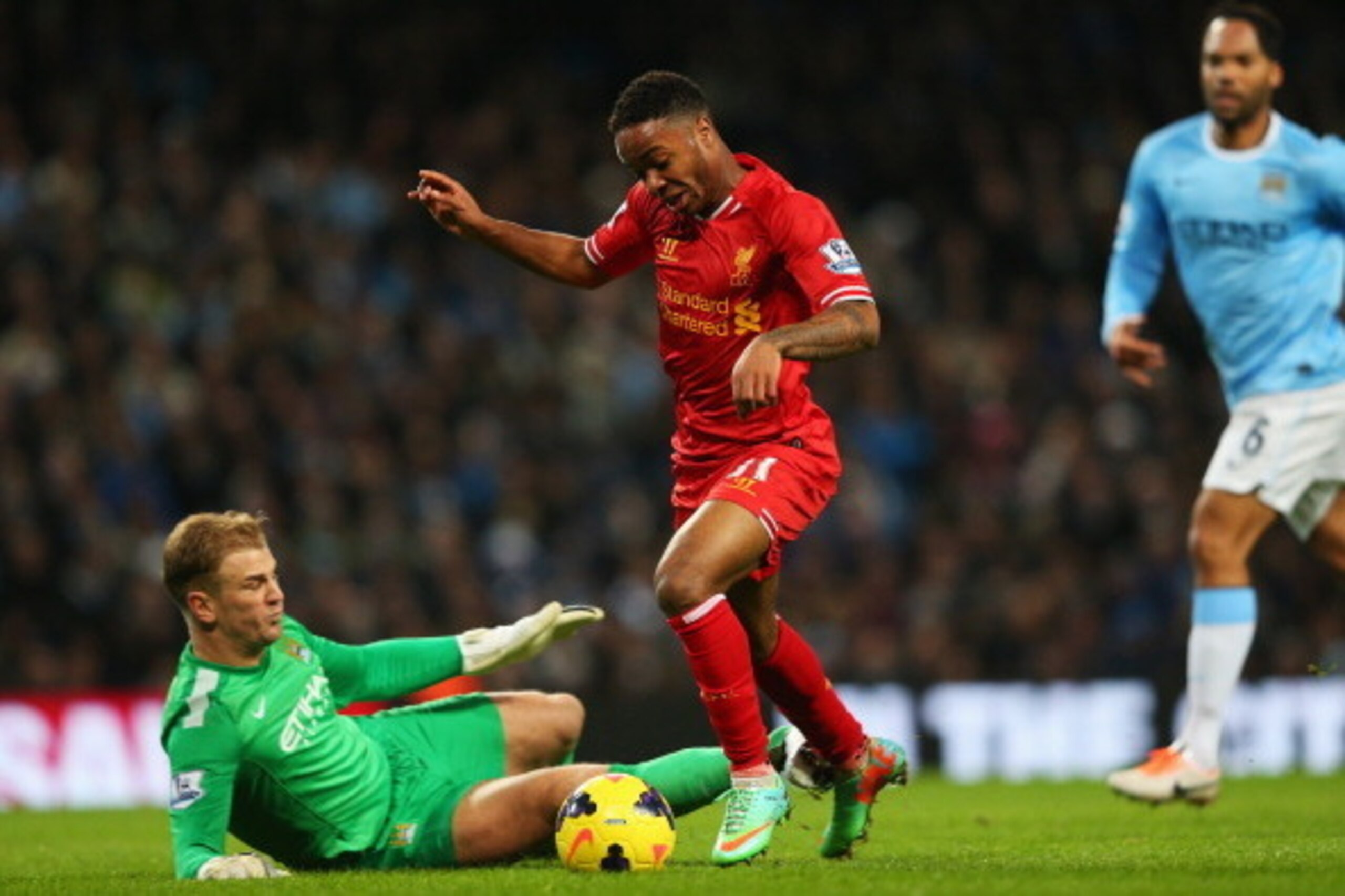 MANCHESTER, ENGLAND - DECEMBER 26: Raheem Sterling of Liverpool rounds goalkeeper Joe Hart of Manchester City on the way to setting up the opening goal scored by Philippe Coutinho during the Barclays Premier League match between Manchester City and Liver MANCHESTER, ENGLAND - DECEMBER 26: Raheem Sterling of Liverpool rounds goalkeeper Joe Hart of Manchester City on the way to setting up the opening goal scored by Philippe Coutinho during the Barclays Premier League match between Manchester City and Liver