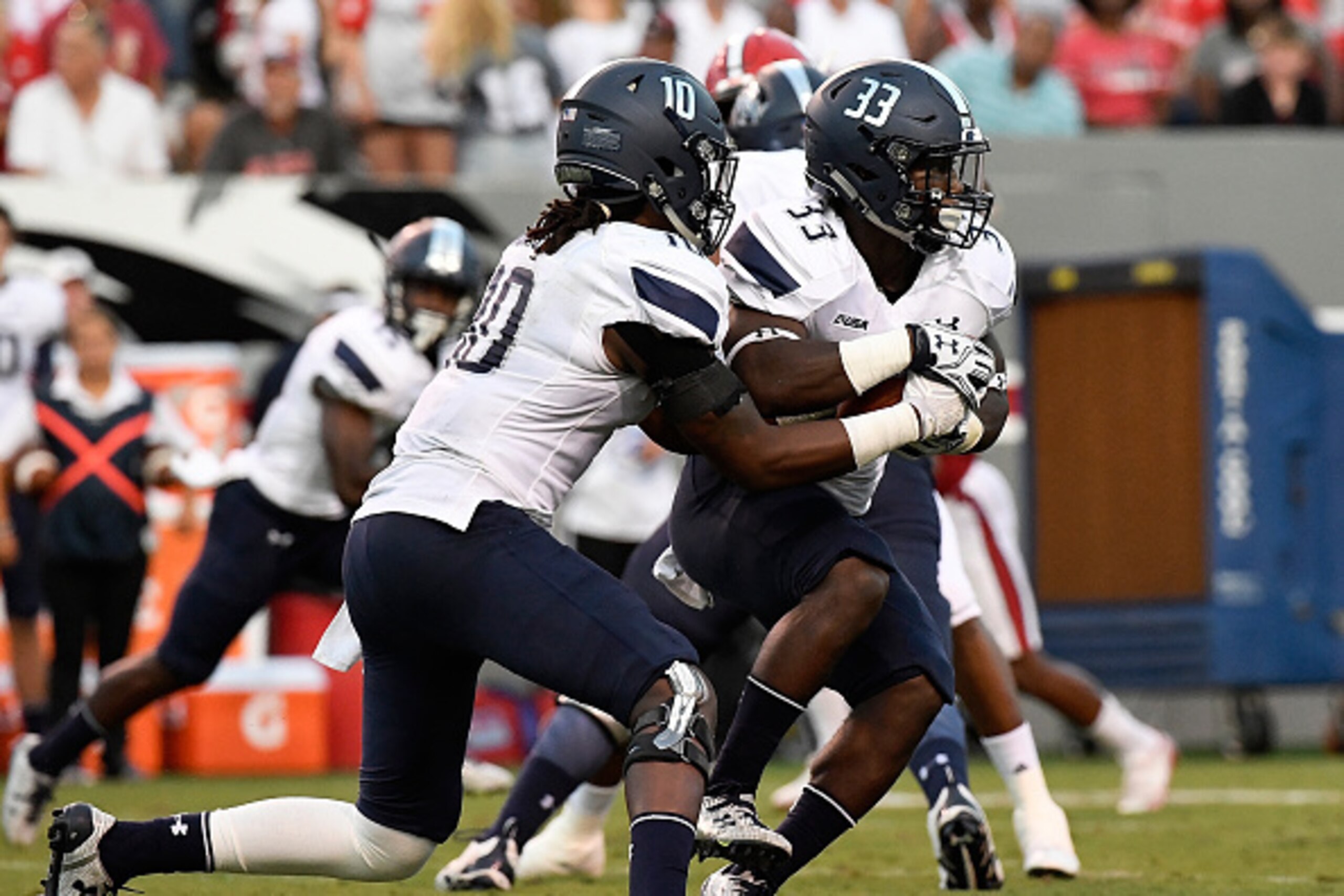 RALEIGH, NC - SEPTEMBER 17: David Washington #10 of the Old Dominion Monarchs hands off to Ray Lawry #33 against the NC State Wolfpack at Carter-Finley Stadium on September 17, 2016 in Raleigh, North Carolina. (Photo by Mike Comer/Getty Images)