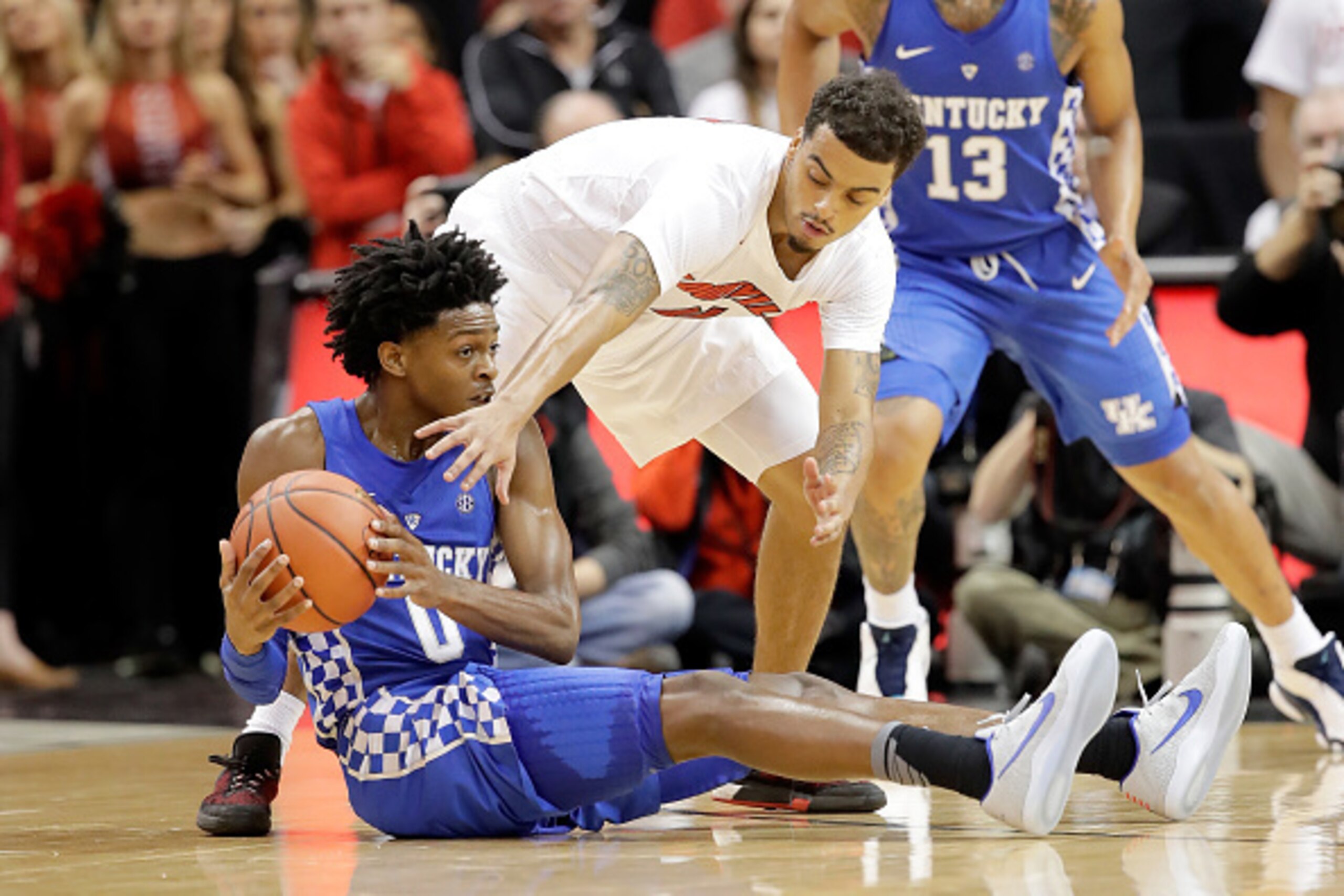LOUISVILLE, KY - DECEMBER 21:  De'Aaron Fox #0 of the Kentucky Wildcats and Quentin Snider #4 of the Louisville Cardinals battle for a loose ball at KFC YUM! Center on December 21, 2016 in Louisville, Kentucky.  (Photo by Andy Lyons/Getty Images)