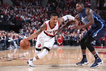PORTLAND, OR - DECEMBER 21: Damian Lillard #0 of the Portland Trail Blazers handles the ball against the Dallas Mavericks on December 21, 2016 at the Moda Center in Portland, Oregon. NOTE TO USER: User expressly acknowledges and agrees that, by downloadin