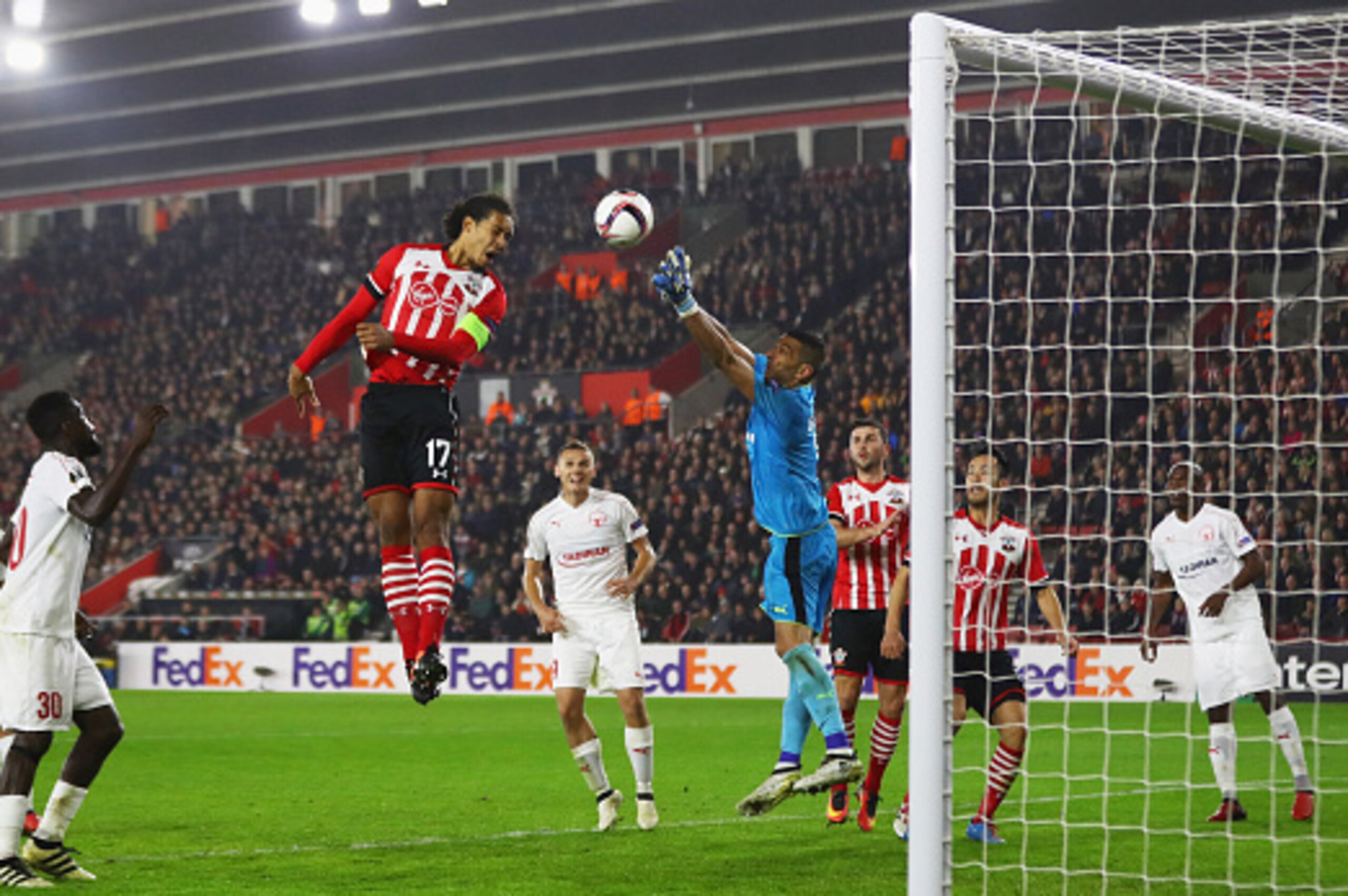 SOUTHAMPTON, ENGLAND - DECEMBER 08:  Virgil van Dijk of Southampton outjumps goalkeeper David Goresh of Hapoel Be'er Sheva during the UEFA Europa League Group K match between Southampton FC and Hapoel Be'er-Sheva FC at St Mary's Stadium on December 8, 201