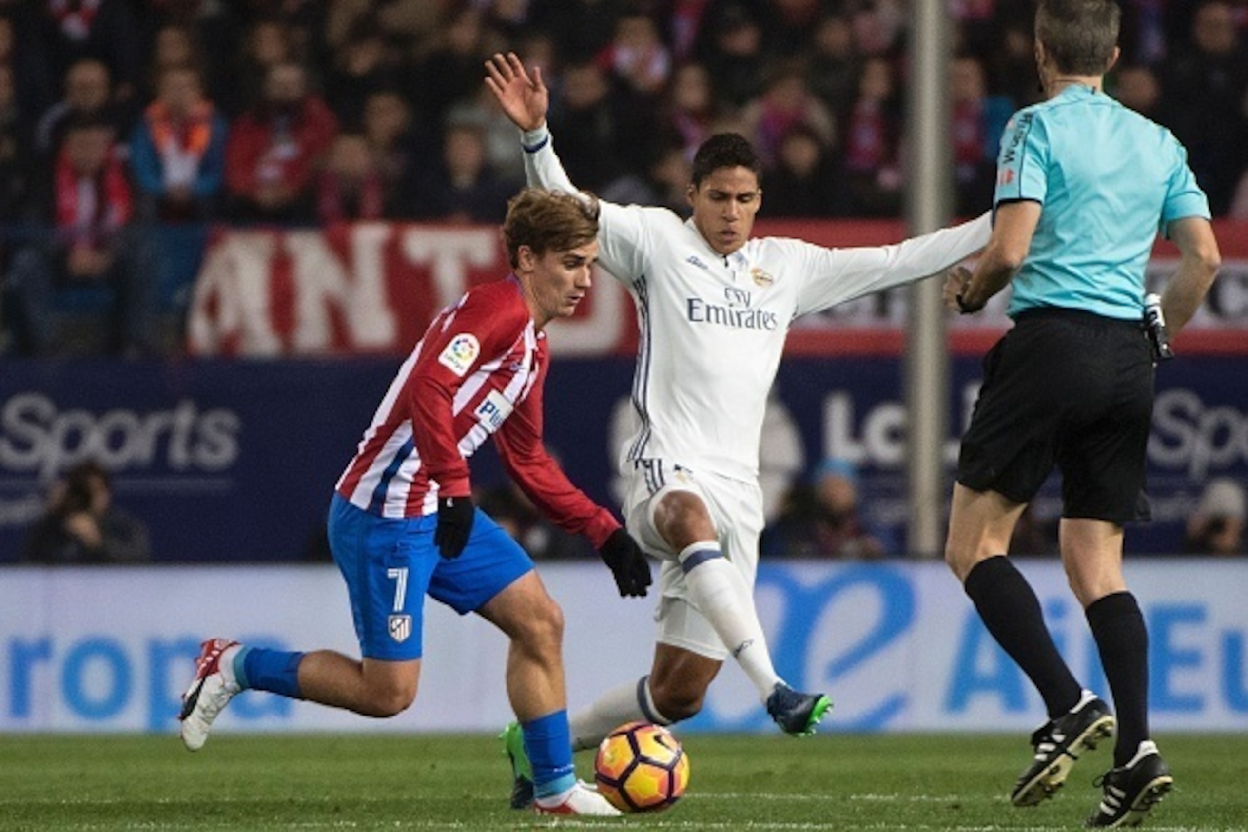 Atletico Madrid's French forward Antoine Griezmann (L) vies with Real Madrid's French defender Raphael Varane during the Spanish league football match Club Atletico de Madrid vs Real Madrid CF at the Vicente Calderon stadium in Madrid, on November 19, 201