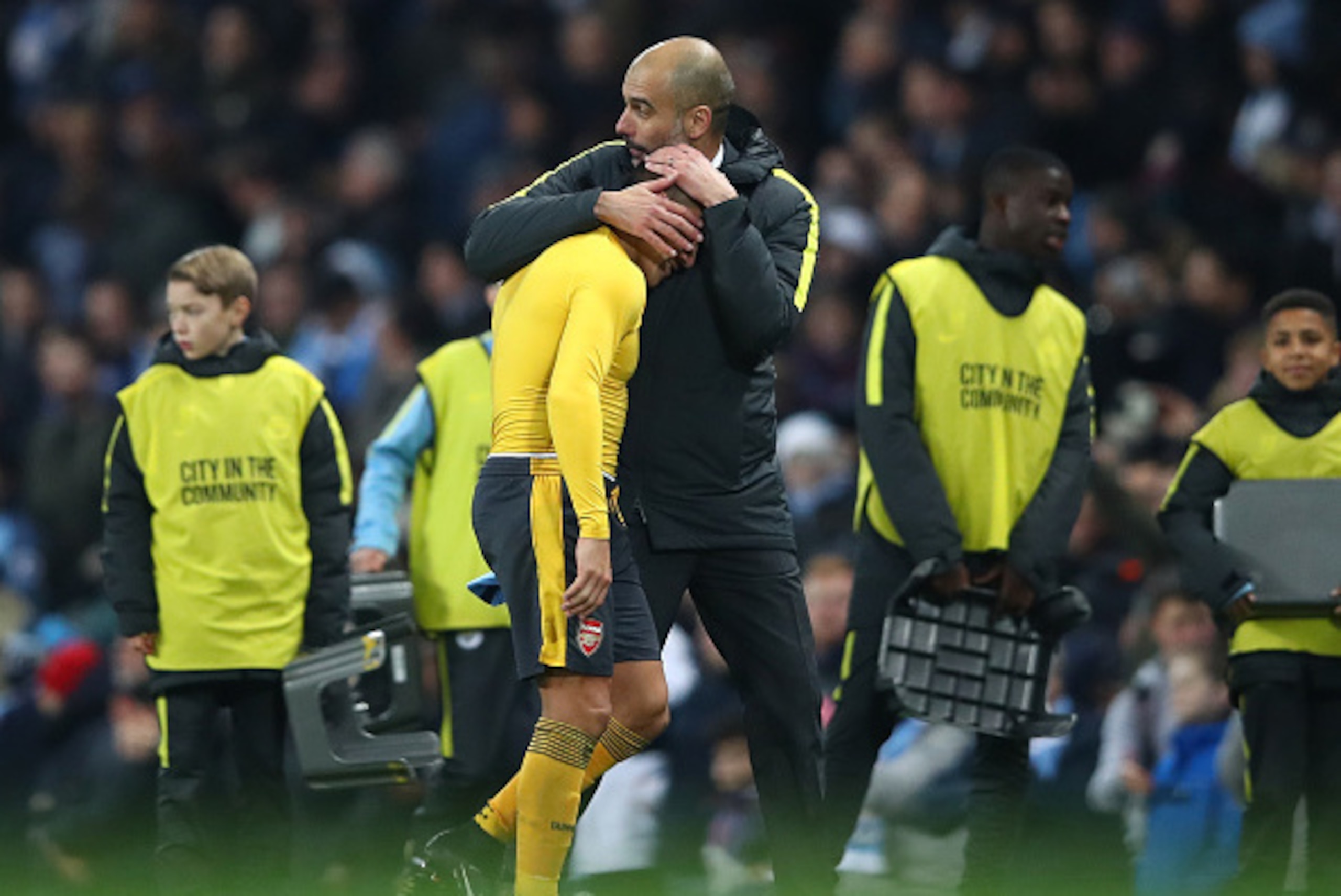 MANCHESTER, ENGLAND - DECEMBER 18:  Alexis Sanchez of Arsenal (L) and Josep Guardiola, Manager of Manchester City (R) embrace after the final whistle during the Premier League match between Manchester City and Arsenal at the Etihad Stadium on December 18,