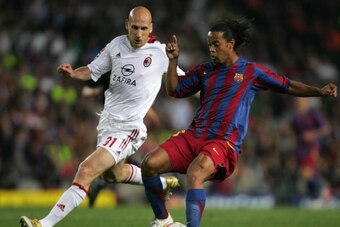 (FILES) -- A file photo taken 26 April 2006 shows Barcelona's Brazilian Ronaldinho (R) vying with AC Milan's Dutch Jaap Stam during their Champions League semi-final second leg football match at the Camp Nou stadium in Barcelona. Stam, 35, former Manchest