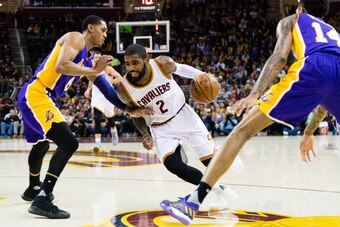 CLEVELAND, OH - DECEMBER 17: Kyrie Irving #2 of the Cleveland Cavaliers drives between Jordan Clarkson #6 and Brandon Ingram #14 of the Los Angeles Lakers during the second half at Quicken Loans Arena on December 17, 2016 in Cleveland, Ohio. The Cavaliers
