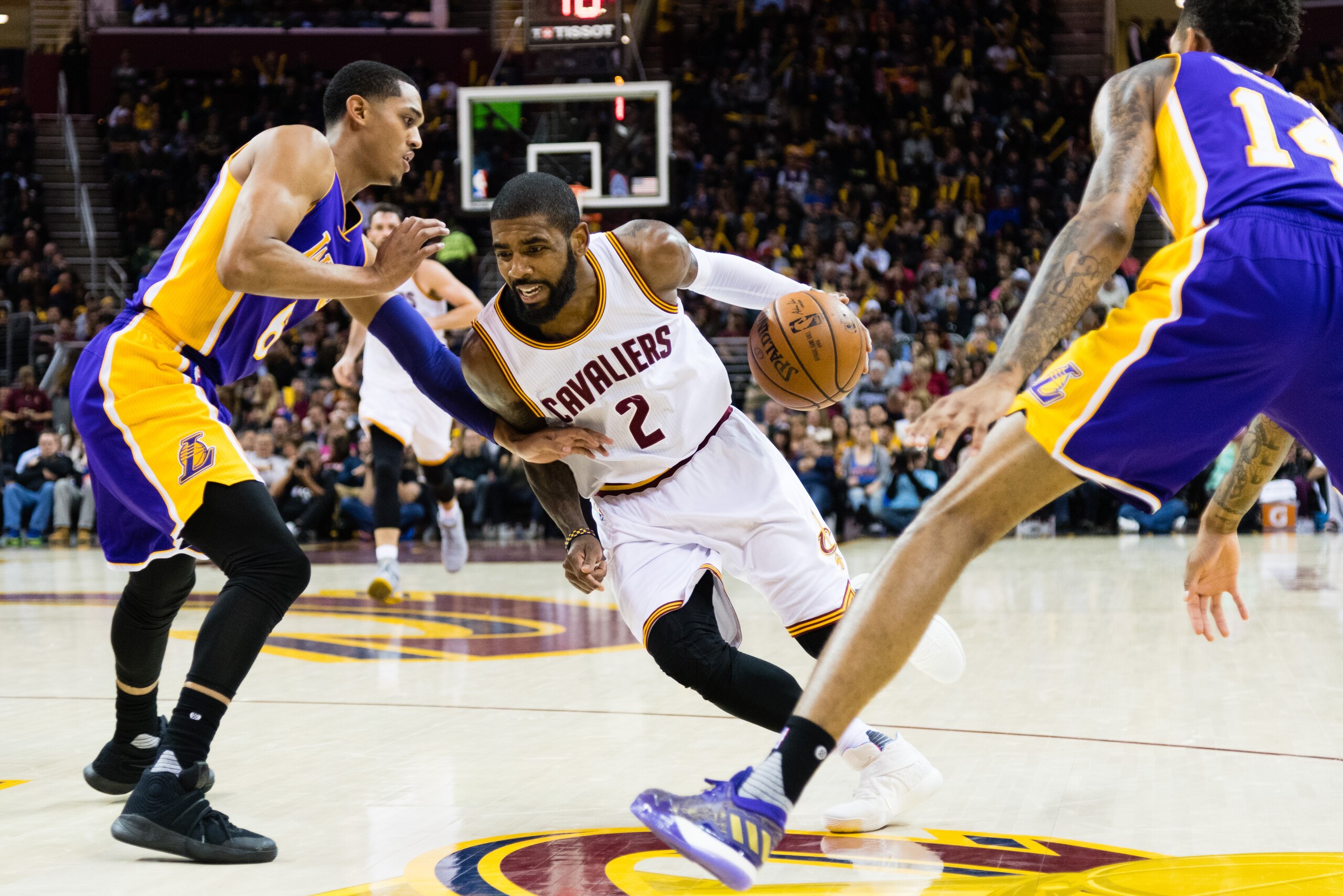CLEVELAND, OH - DECEMBER 17: Kyrie Irving #2 of the Cleveland Cavaliers drives between Jordan Clarkson #6 and Brandon Ingram #14 of the Los Angeles Lakers during the second half at Quicken Loans Arena on December 17, 2016 in Cleveland, Ohio. The Cavaliers CLEVELAND, OH - DECEMBER 17: Kyrie Irving #2 of the Cleveland Cavaliers drives between Jordan Clarkson #6 and Brandon Ingram #14 of the Los Angeles Lakers during the second half at Quicken Loans Arena on December 17, 2016 in Cleveland, Ohio. The Cavaliers