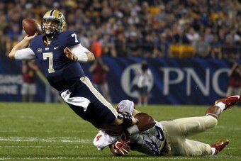 PITTSBURGH, PA - SEPTEMBER 02:  Tom Savage #7 of the Pittsburgh Panthers throws the ball away in the first half against DeMarcus Walker #44 of the Florida State Seminoles during the game on September 2, 2013 at Heinz Field in Pittsburgh, Pennsylvania.  (P