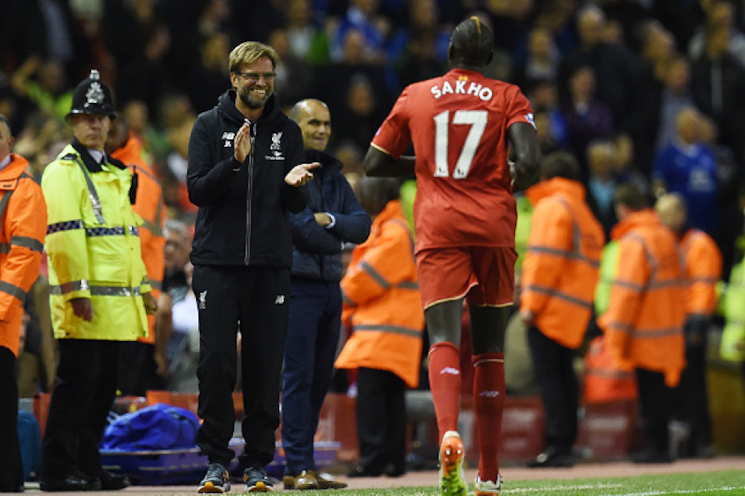 Liverpool's French defender Mamadou Sakho (R) celebrates with Liverpool's German manager Jurgen Klopp after scoring during the English Premier League football match between Liverpool and Everton at Anfield in Liverpool, north west England on April 20, 201