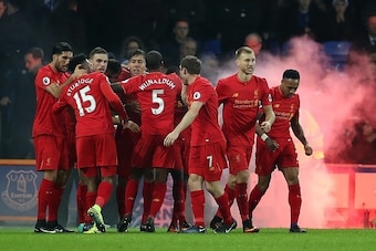 LIVERPOOL, ENGLAND - DECEMBER 19: Sadio Mane of Liverpool is congratulated by his team-mates after scoring his side's opening goal during the Premier League match between Everton and Liverpool at Goodison Park on December 19, 2016 in Liverpool, England. (