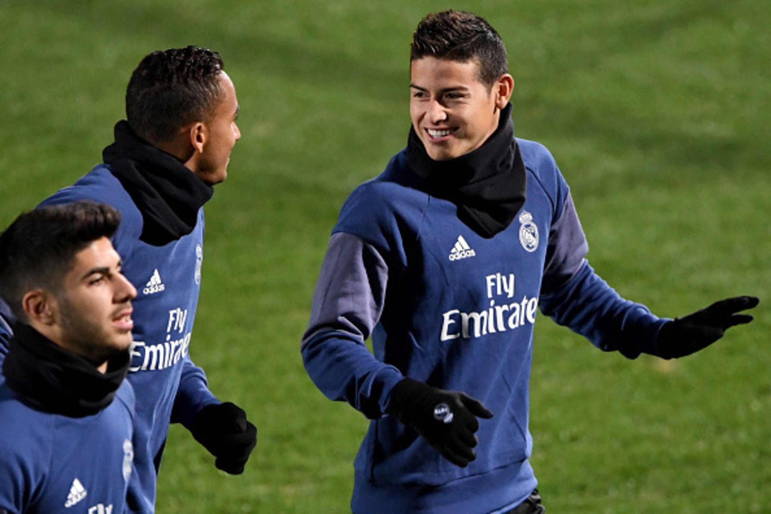 Real Madrid's midfielder James Rodriguez (R) chats with his teammate during a training session at Mitsuzawa stadium in Yokohama on December 16, 2016, ahead of their Club World Cup football final match against Kashima Antlers of Japan on December 18. / AFP