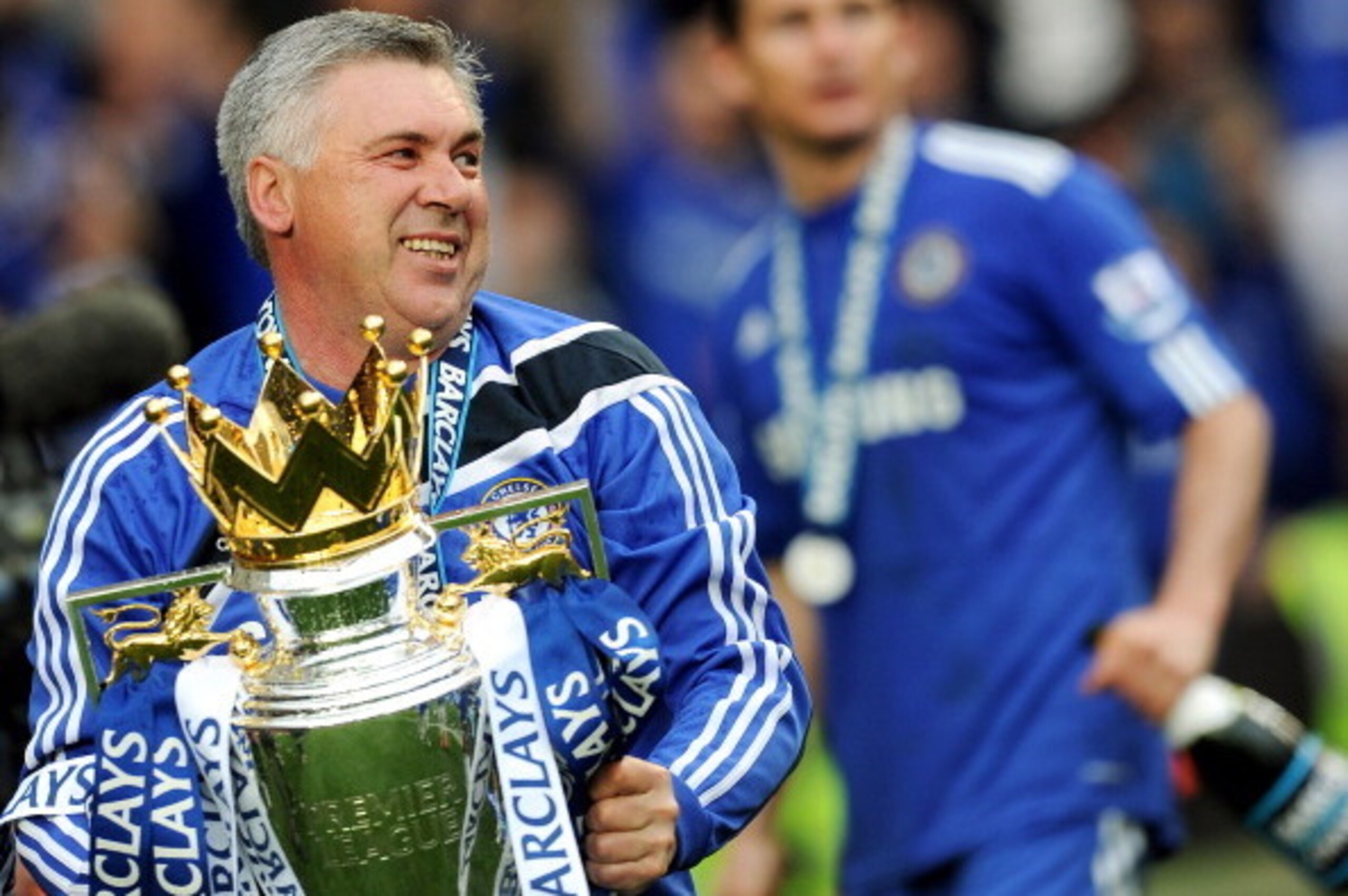 Chelsea's Italian manager Carlo Ancelotti celebrates with the Barclays Premier League trophy after Chelsea win the title with a 8-0 victory over Wigan Athletic in the English Premier League football match at Stamford Bridge, West London, England, on May 9