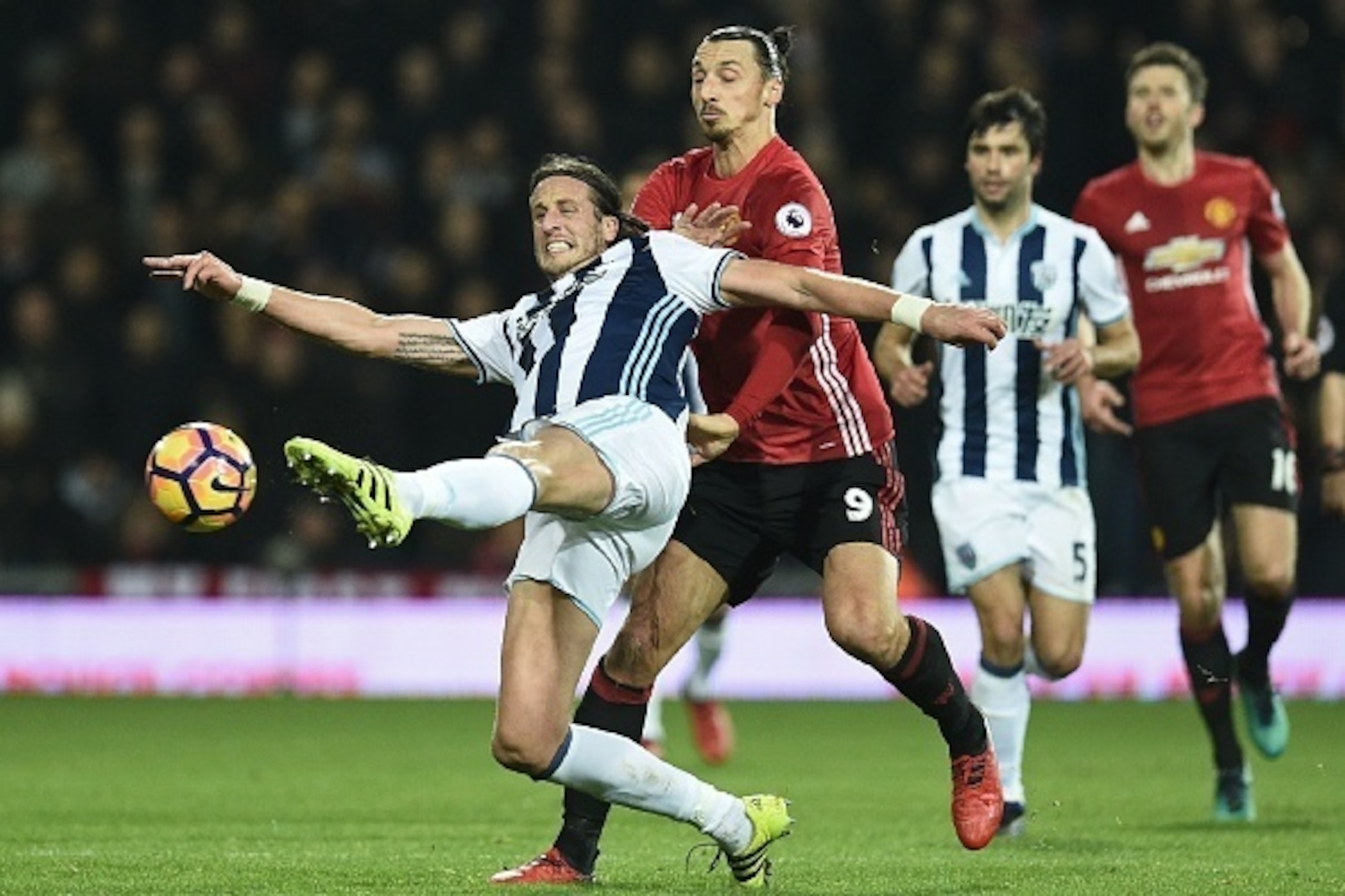 West Bromwich Albion's Swedish defender Jonas Olsson (L) clears the ball under presure from Manchester United's Swedish striker Zlatan Ibrahimovic during the English Premier League football match between West Bromwich Albion and Manchester United at The H