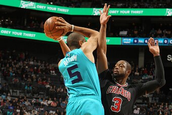CHARLOTTE, NC - DECEMBER 23:  Dwyane Wade #3 of the Chicago Bulls plays defense against Nicolas Batum #5 of the Charlotte Hornets during the game on December 23, 2016 at Spectrum Center in Charlotte, North Carolina. NOTE TO USER: User expressly acknowledg