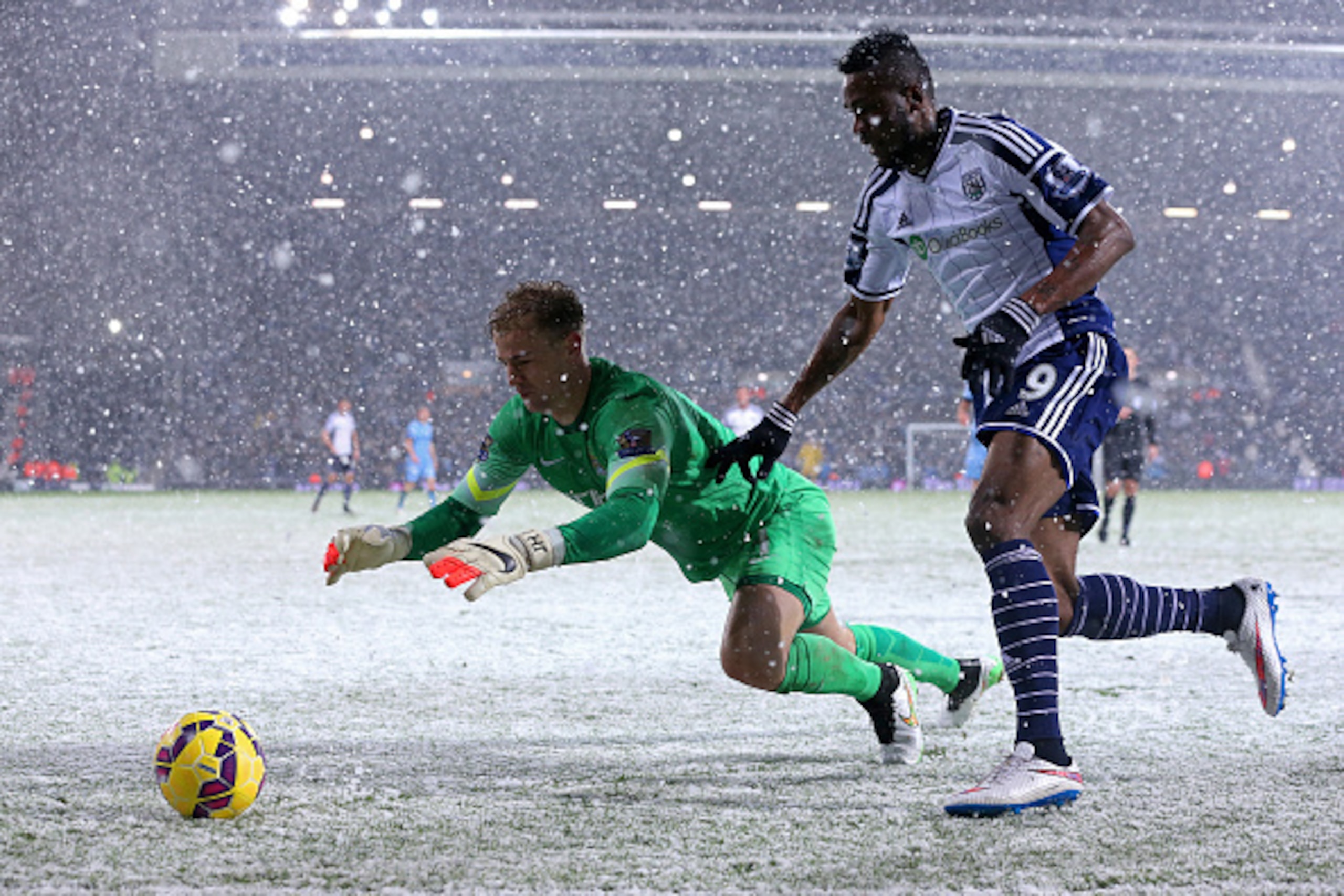 WEST BROMWICH, ENGLAND - DECEMBER 26: Joe Hart of Manchester City dives for the ball under pressure from Brown Ideye of West Brom during the Barclays Premier League match between West Bromwich Albion and Manchester City at The Hawthorns on December 26, 2 WEST BROMWICH, ENGLAND - DECEMBER 26: Joe Hart of Manchester City dives for the ball under pressure from Brown Ideye of West Brom during the Barclays Premier League match between West Bromwich Albion and Manchester City at The Hawthorns on December 26, 2