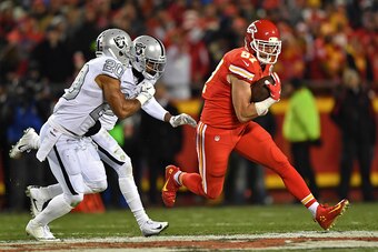 KANSAS CITY, MO - DECEMBER 08:  Tight end Travis Kelce #87 of the Kansas City Chiefs runs up field against safety Nate Allen #20 of the Oakland Raiders during the first half on December 8, 2016 at Arrowhead Stadium in Kansas City, Missouri.  (Photo by Pet