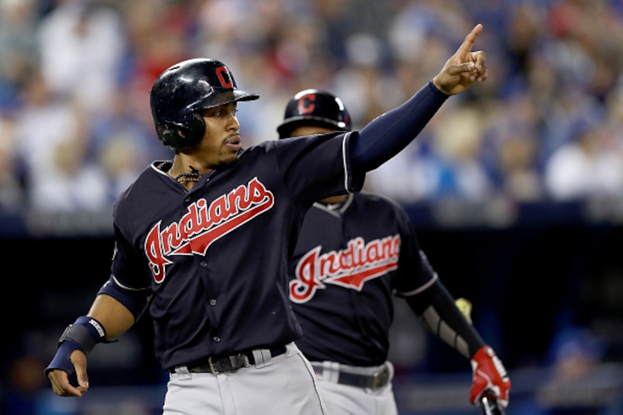 TORONTO, ON - OCTOBER 19:  Francisco Lindor #12 of the Cleveland Indians celebrates after scoring a run off of a double hit by Mike Napoli #26 in the first inning against Marco Estrada #25 of the Toronto Blue Jays during game five of the American League C